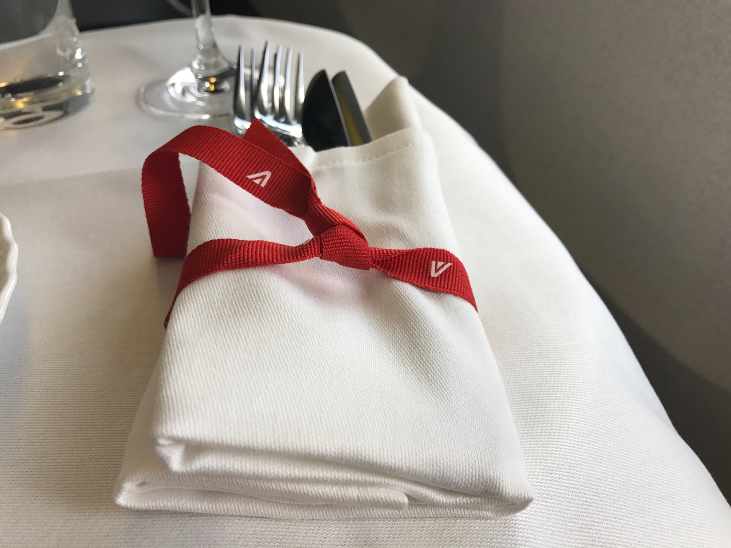 a napkin with a red ribbon on it