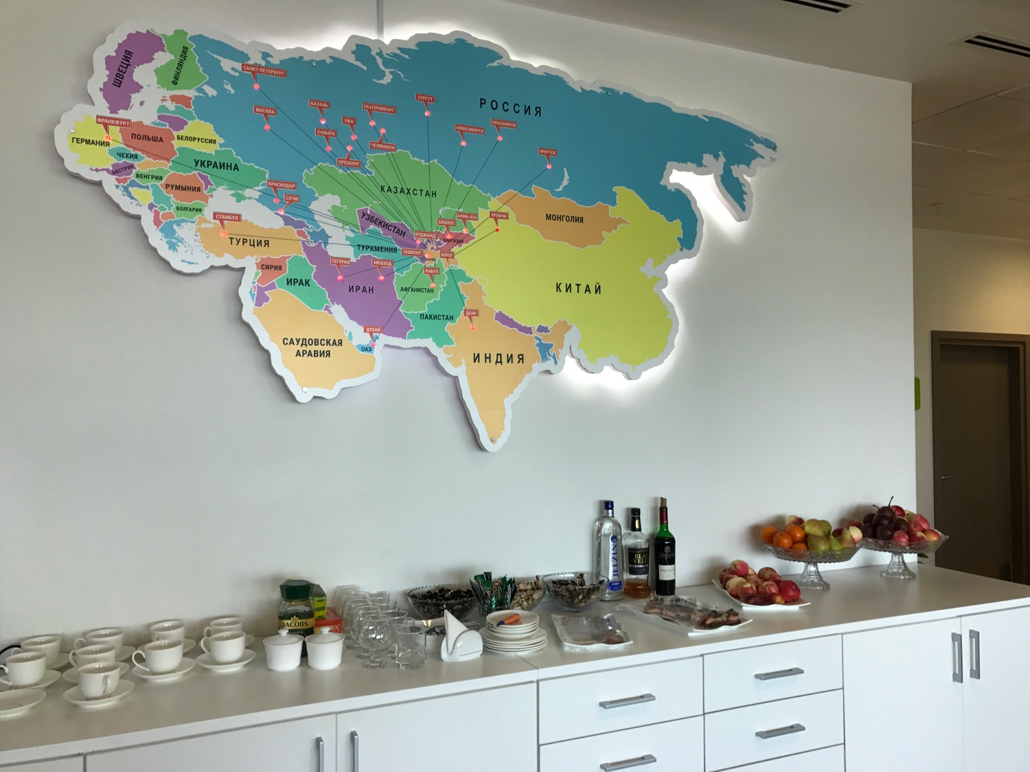 a map of the world with different colored objects on the wall