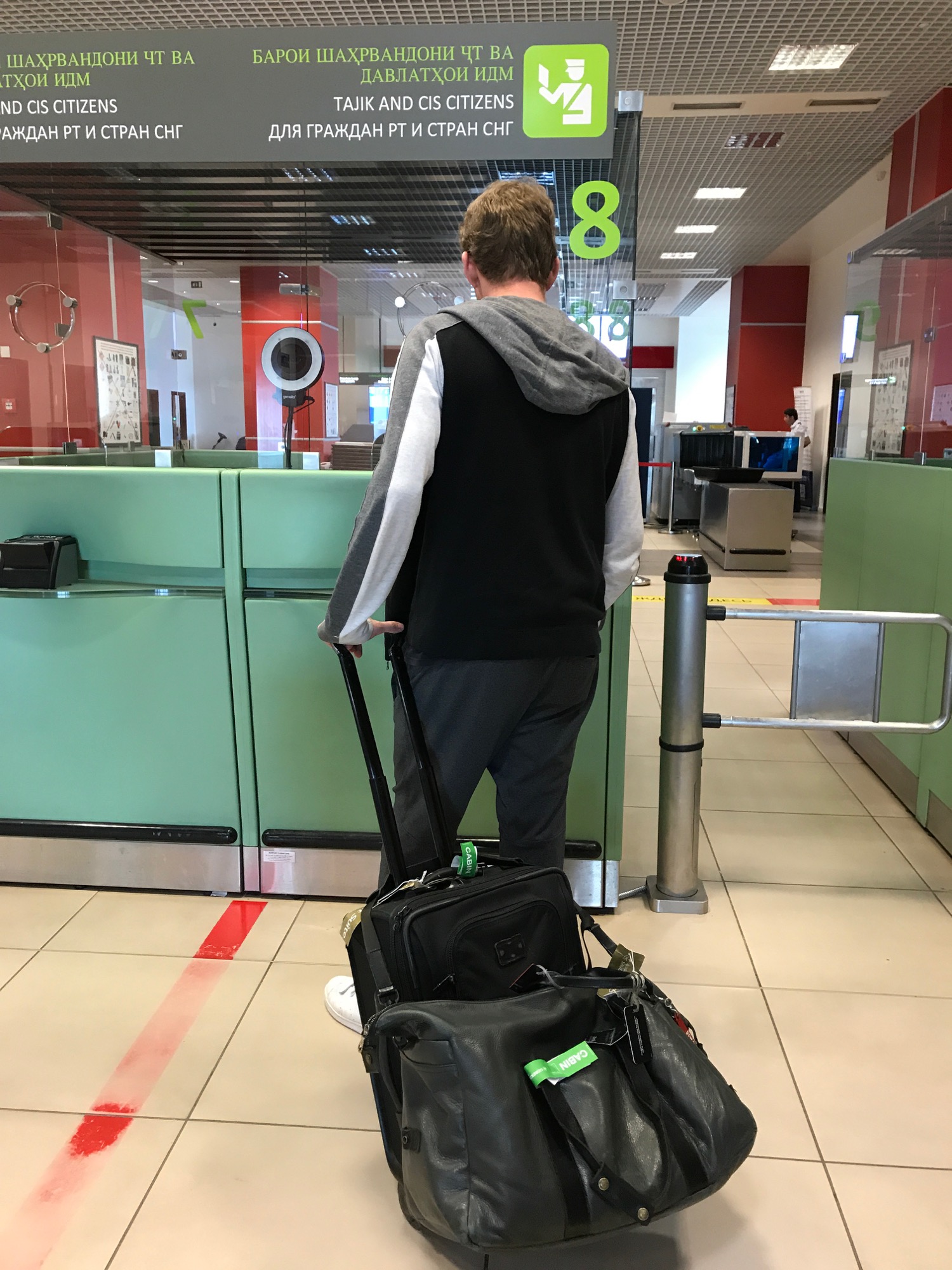 a man with luggage in a airport