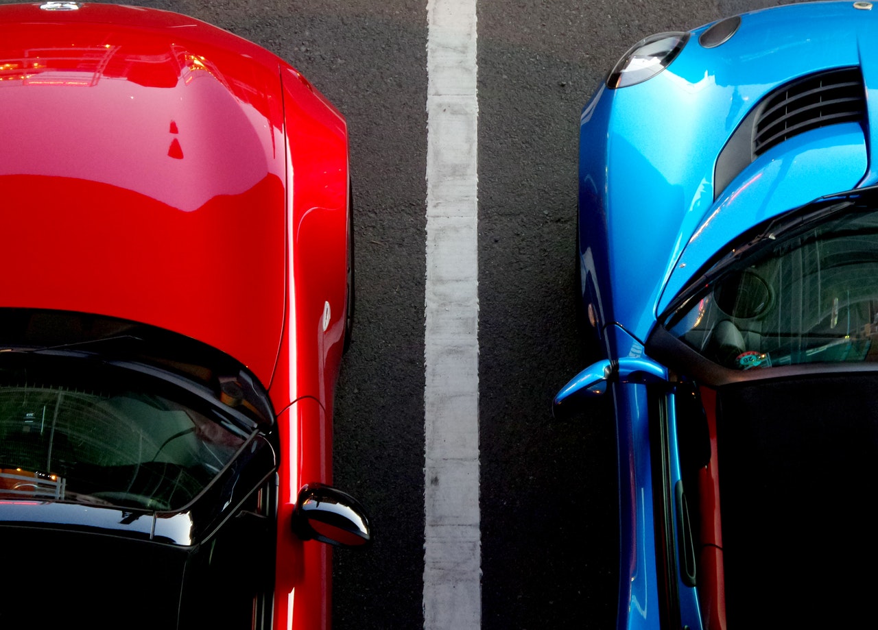 a red and blue sports cars parked on a street