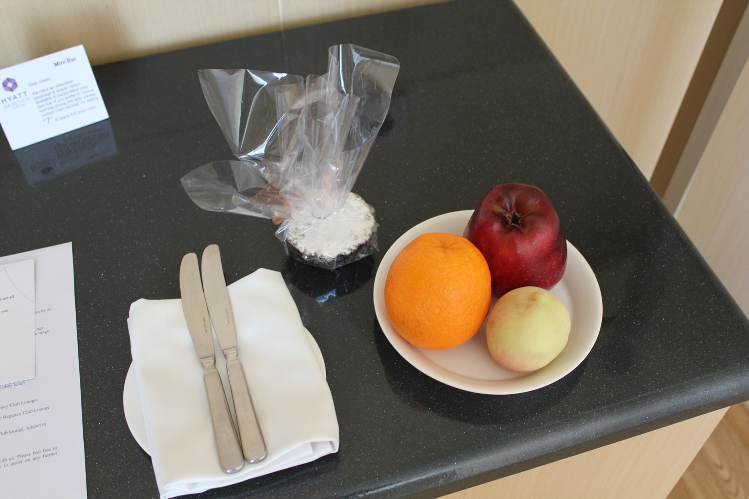 a plate of fruit and a napkin on a table