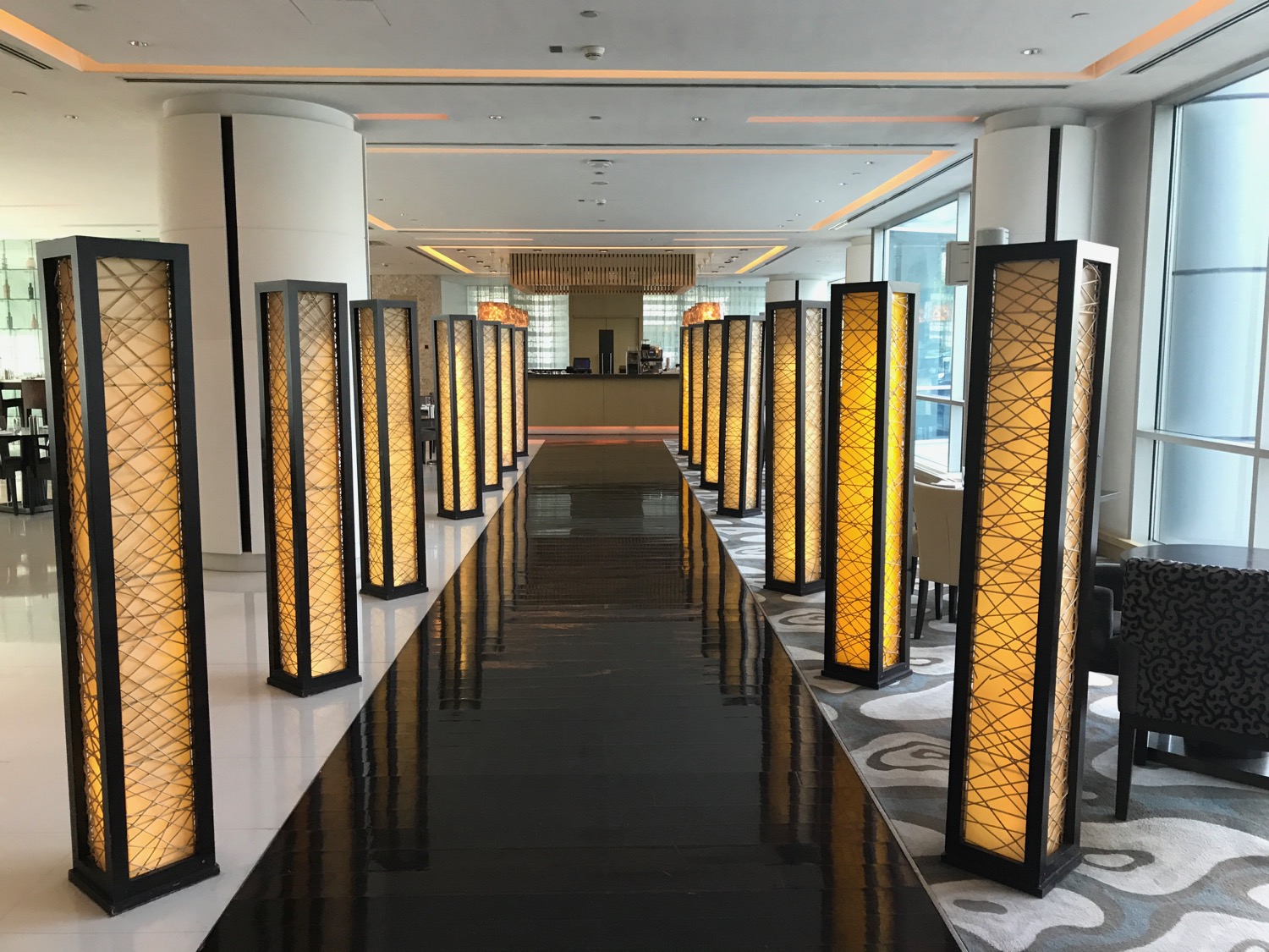 a long hallway with tall pillars