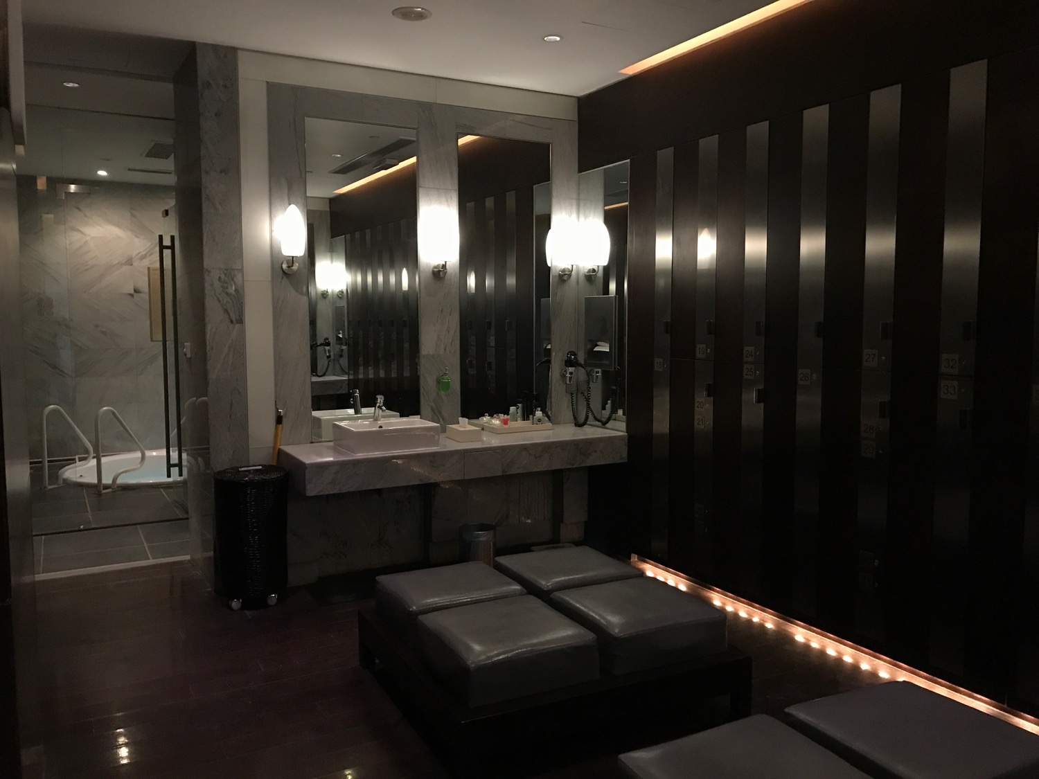 a bathroom with a mirror and stools
