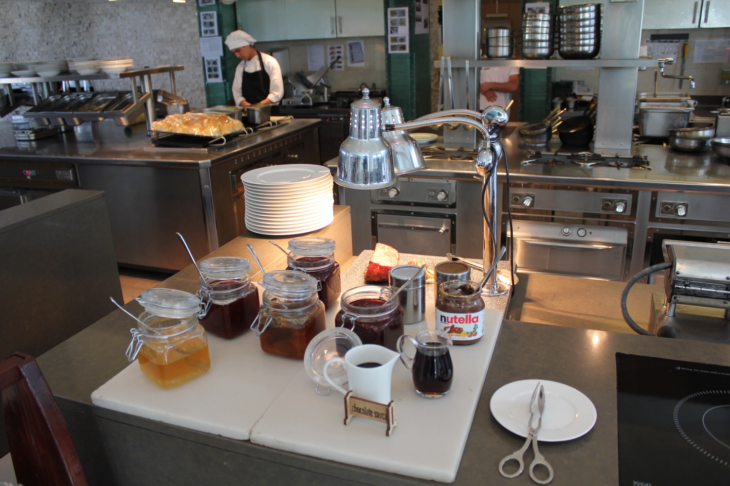 a kitchen with jars of jam and plates