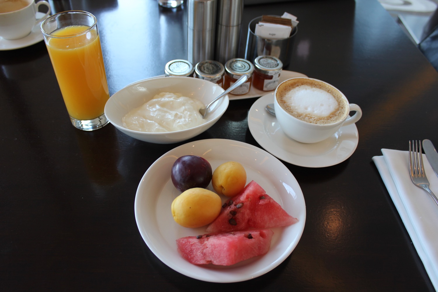 a plate of fruit and a cup of coffee
