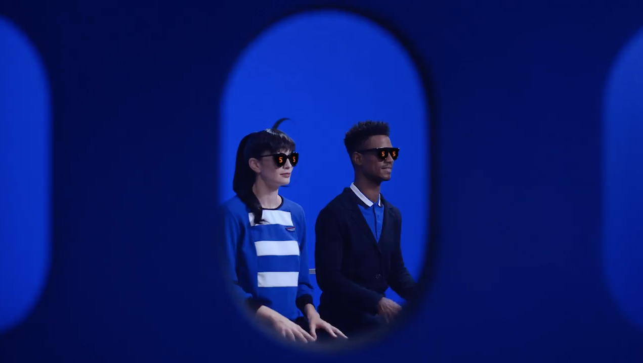 a man and woman sitting in a blue room