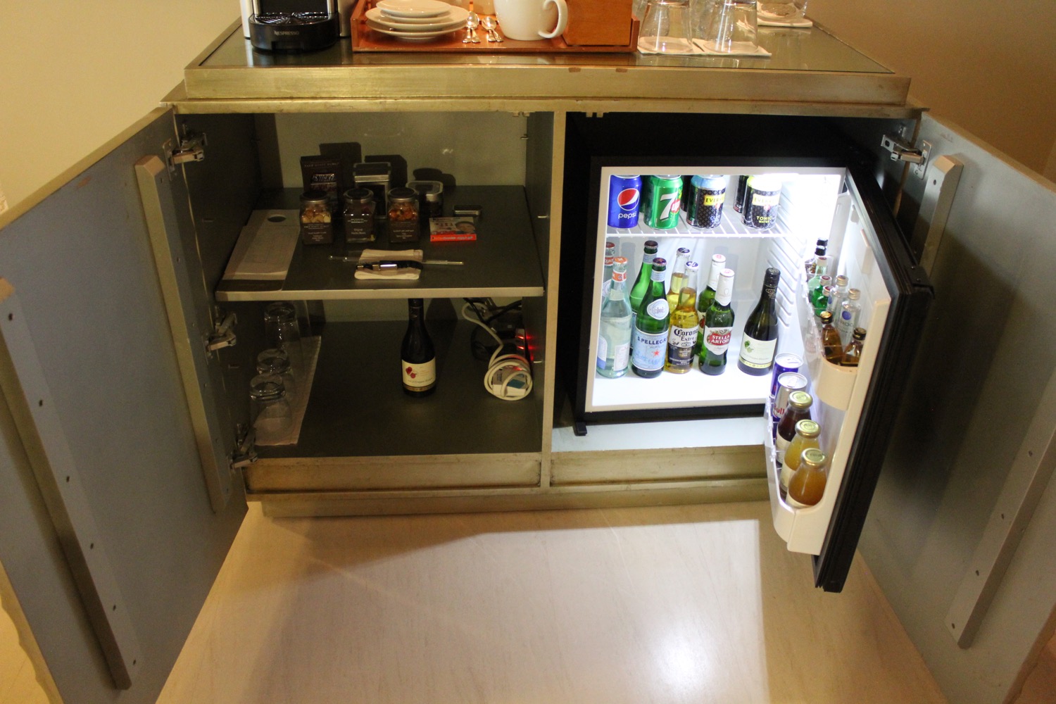 a mini fridge with drinks and bottles inside