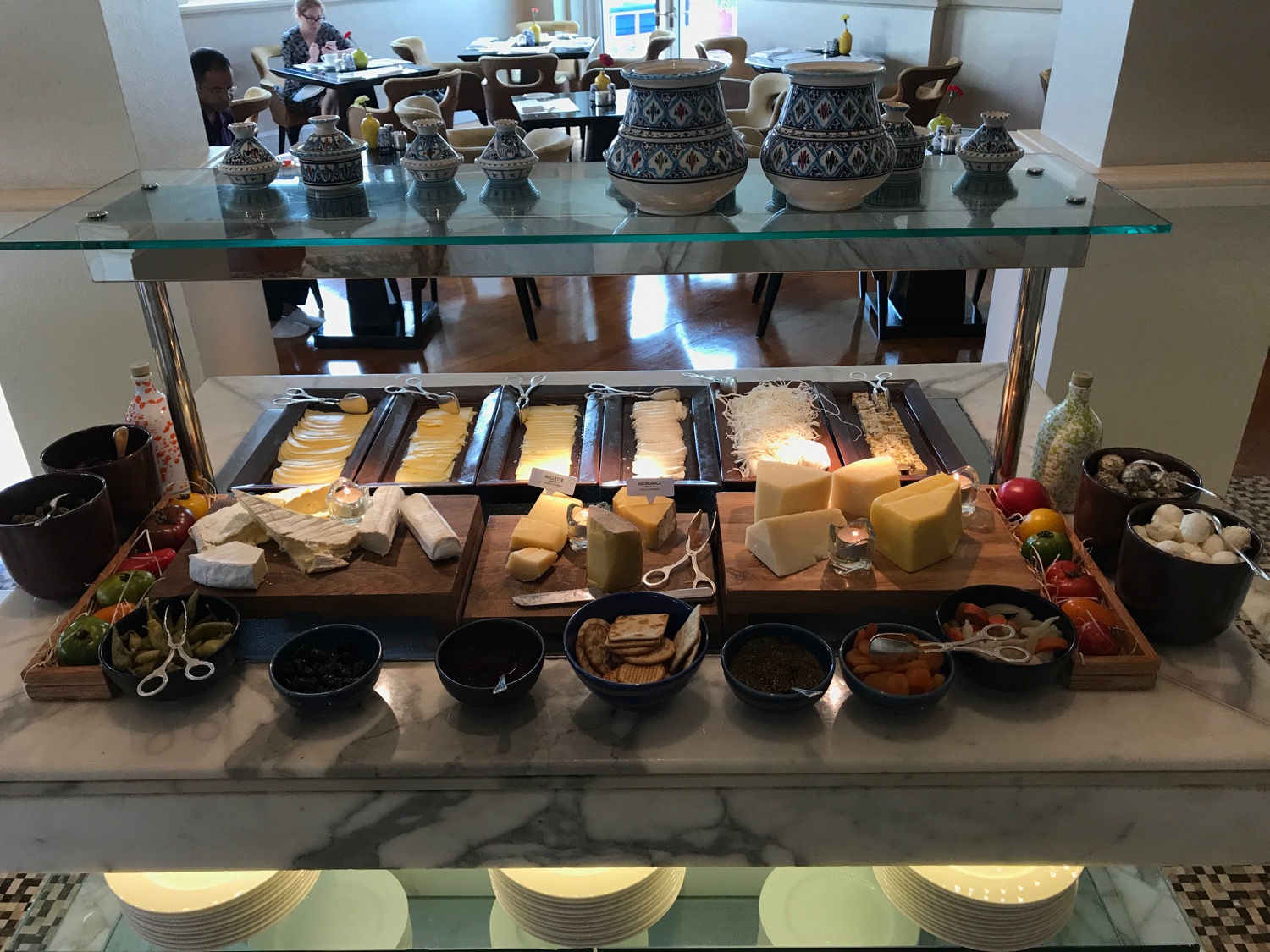 a buffet table with different types of cheese and other food items