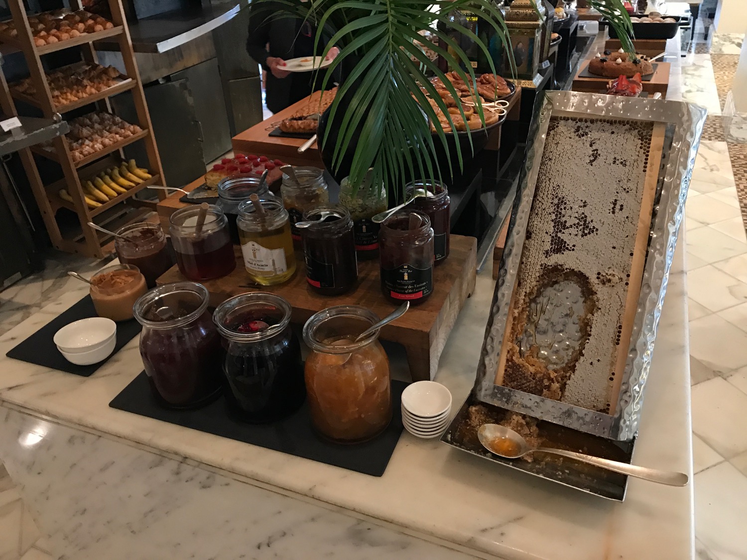 a table with jars of jam and honey