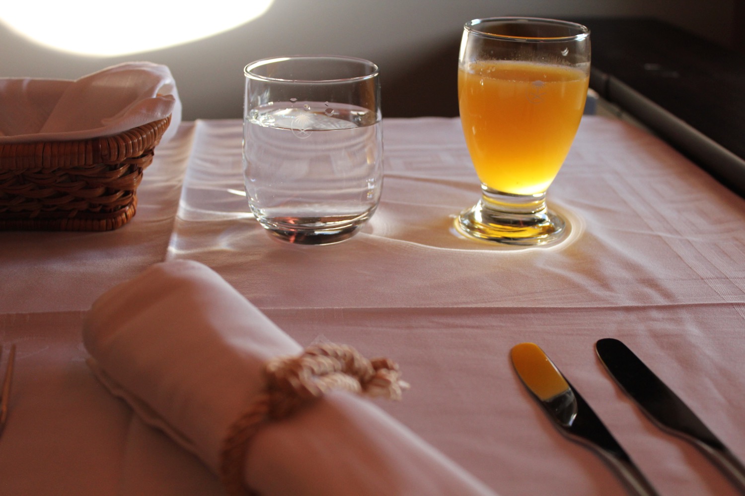 a table with a glass of water and a knife
