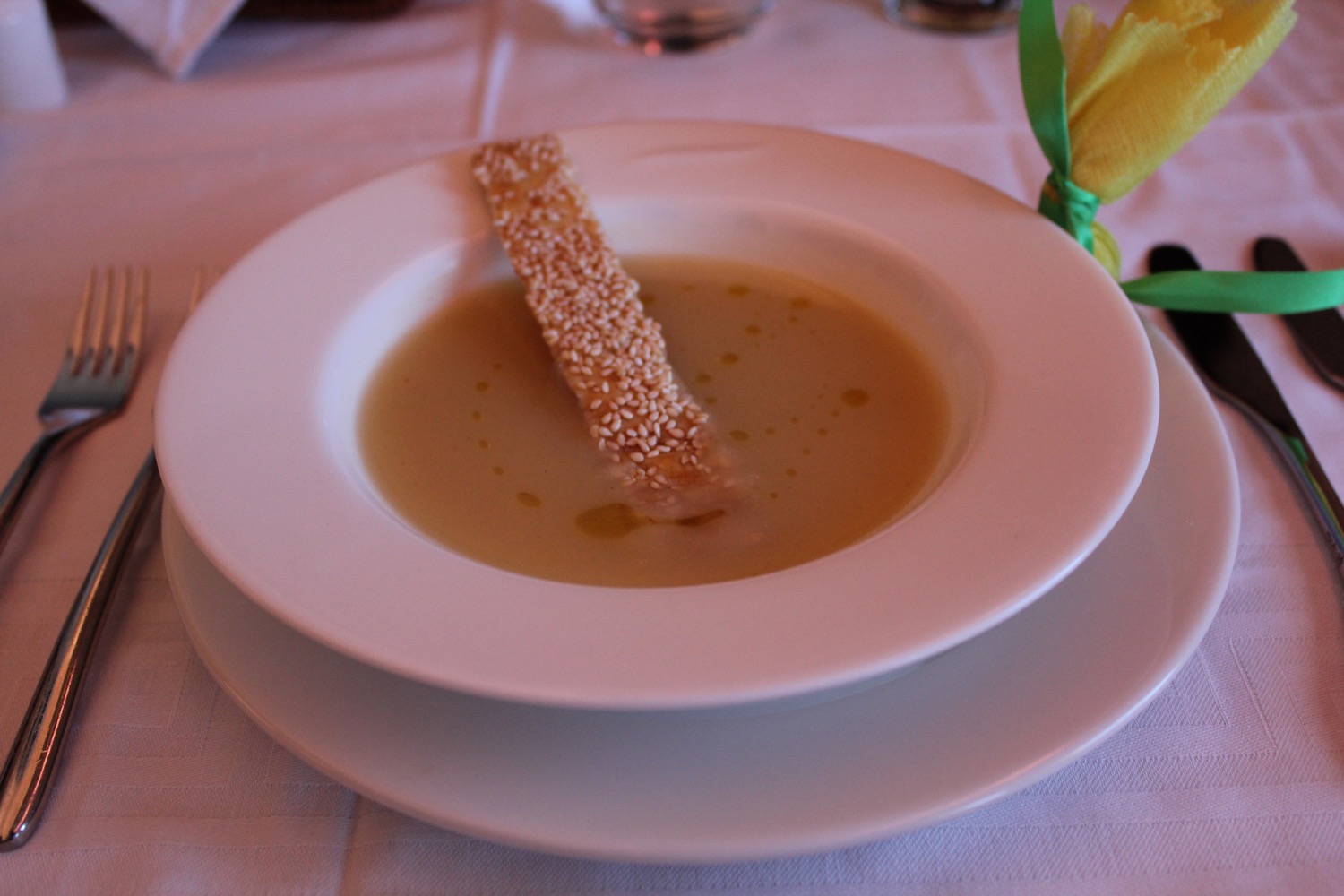 a plate of soup with a stick in it
