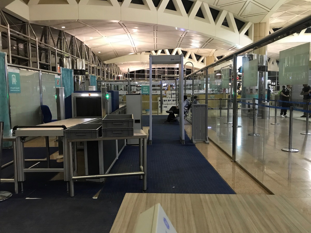 an airport with a glass wall and a metal table
