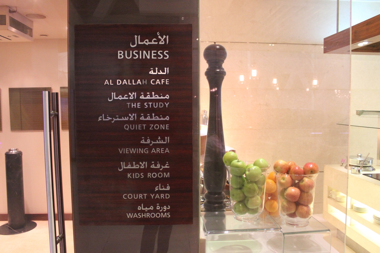 a sign with a menu and fruits in a glass case