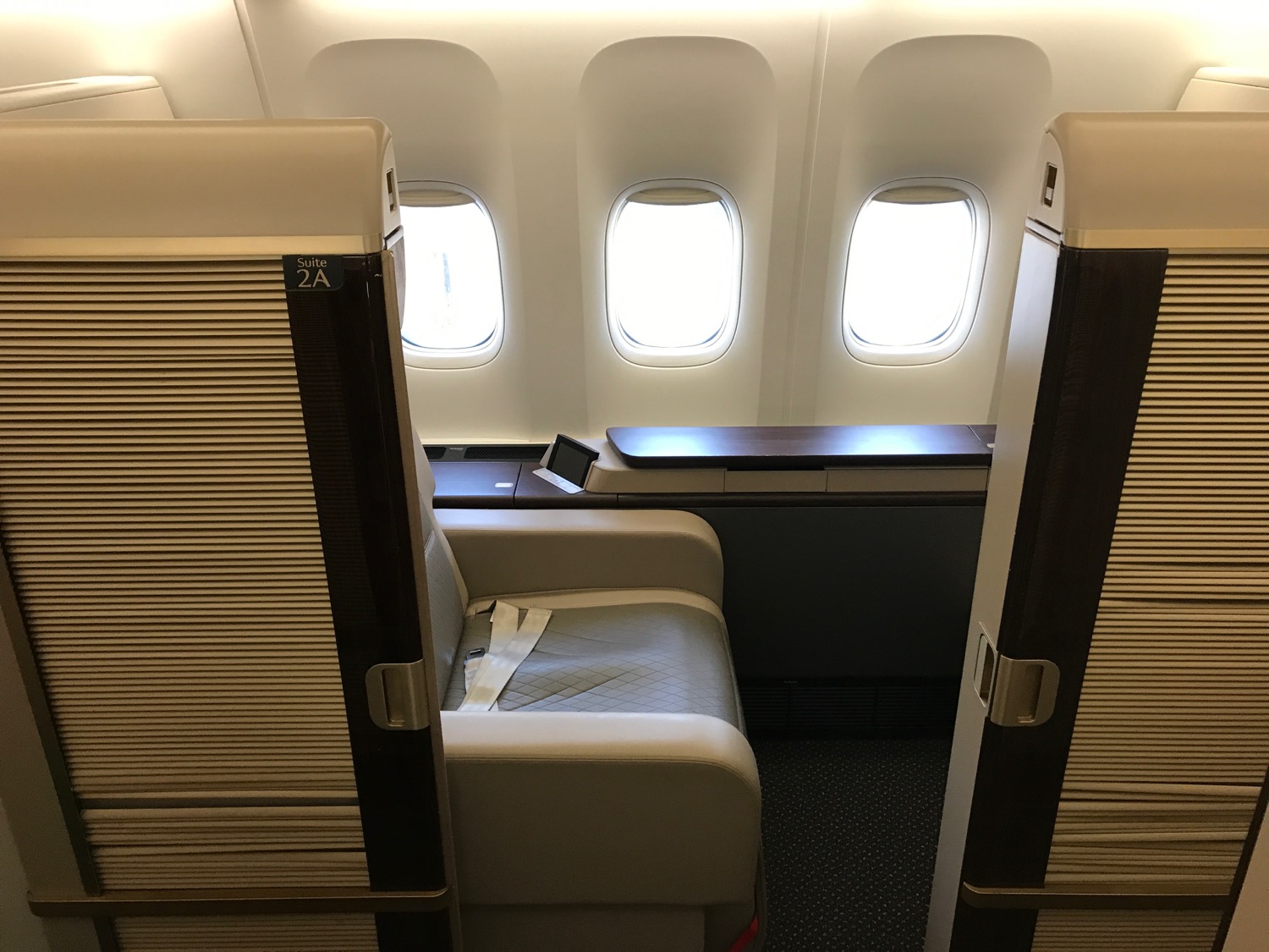 an airplane seat with windows and a table