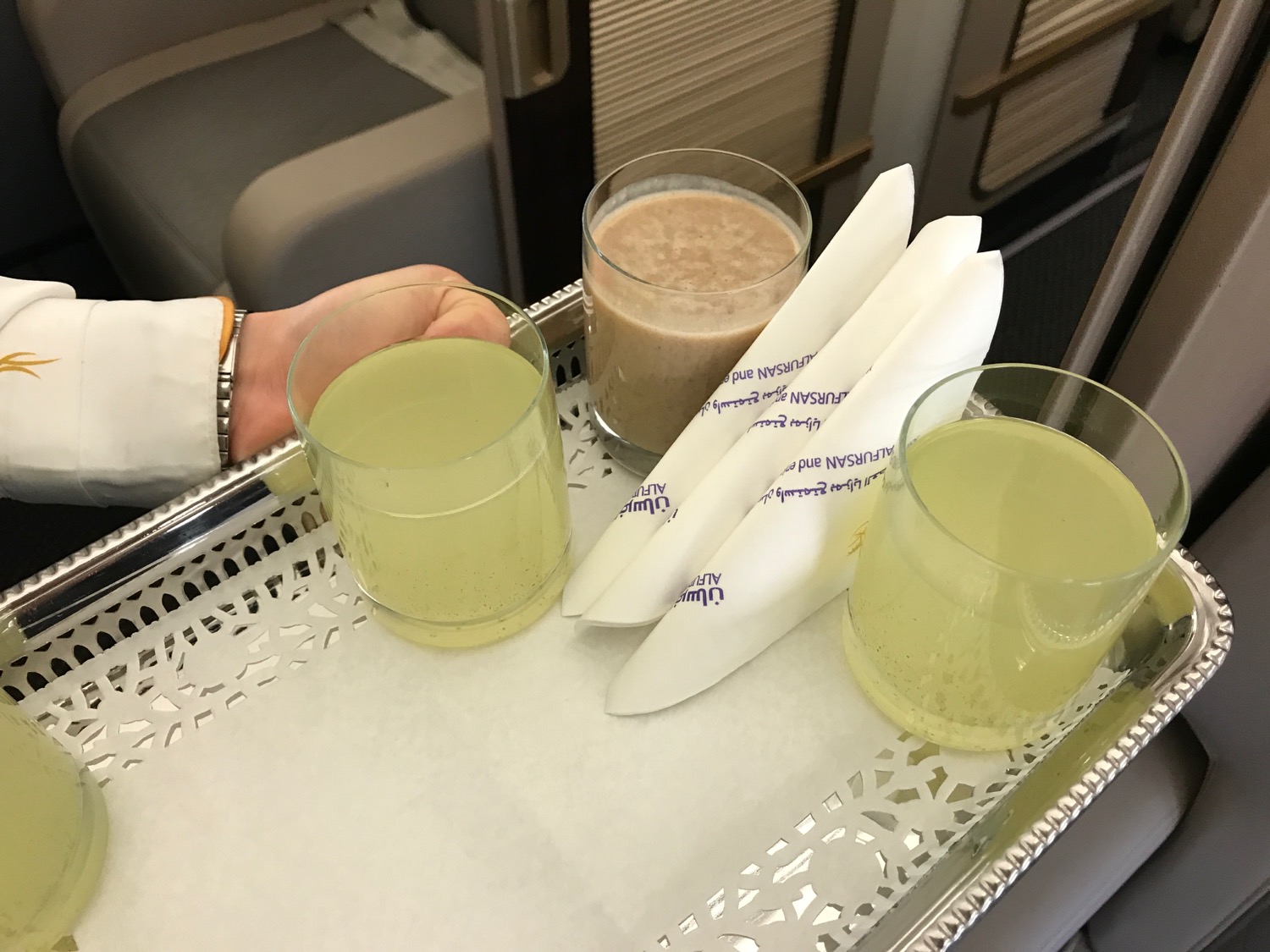 a tray with glasses and napkins on it