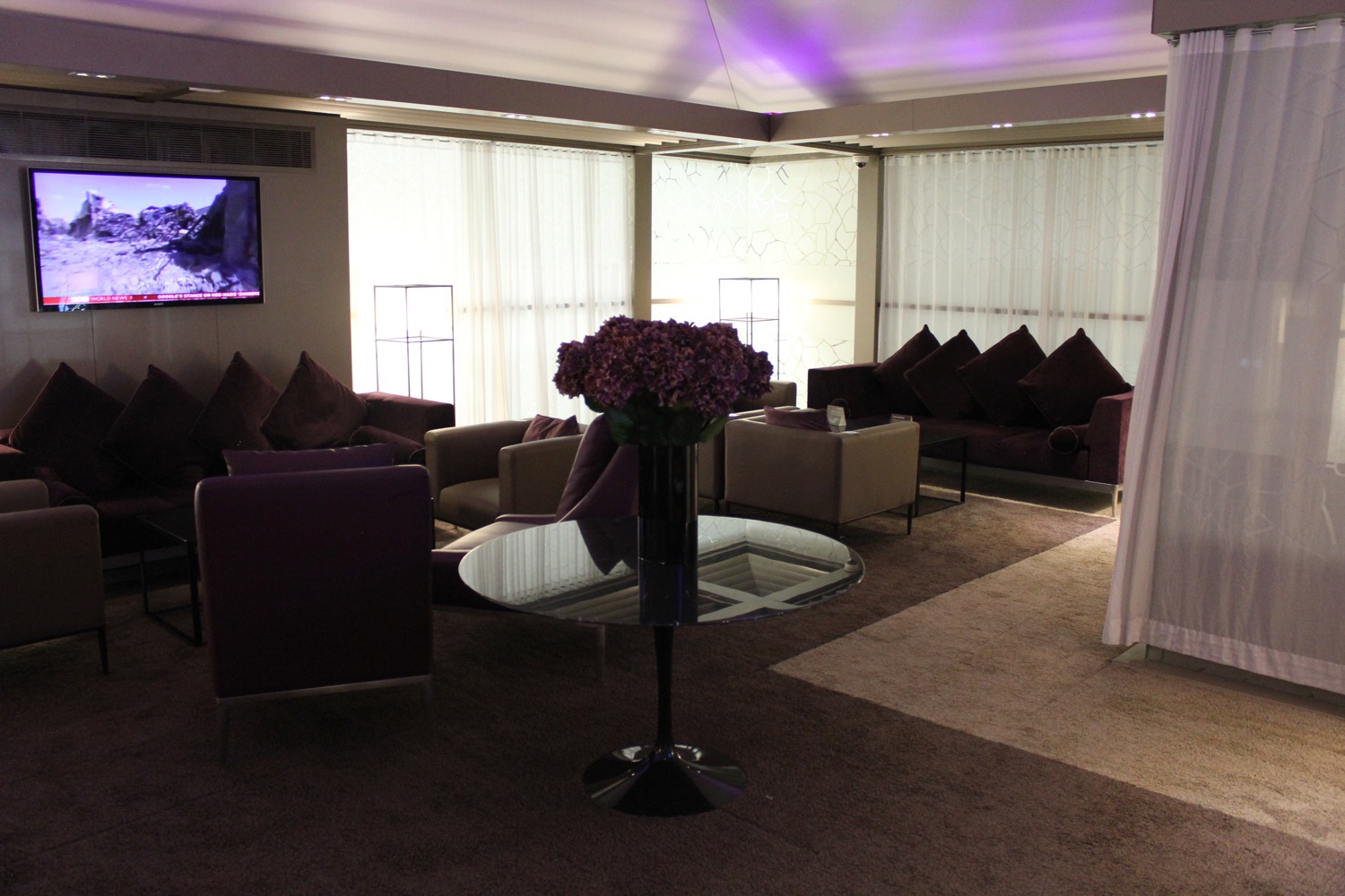 a room with purple furniture and a table