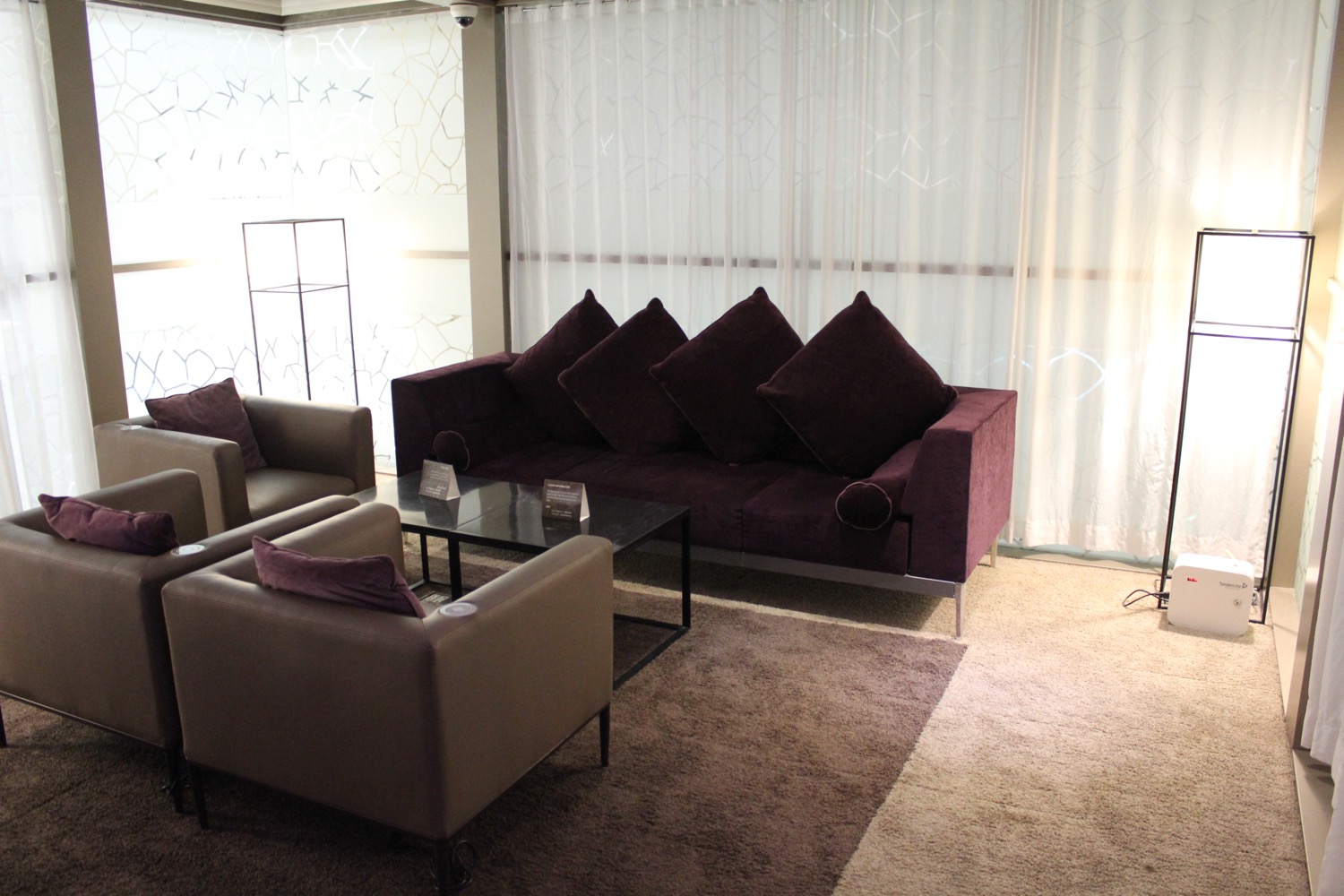 a room with purple couches and chairs