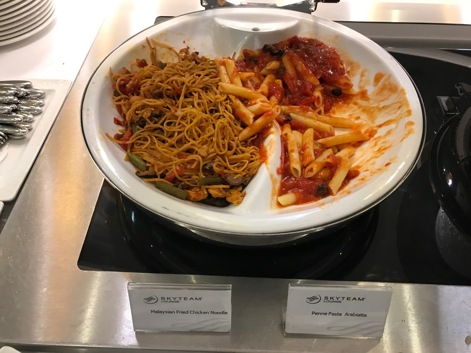 a plate of pasta and sauce on a stove