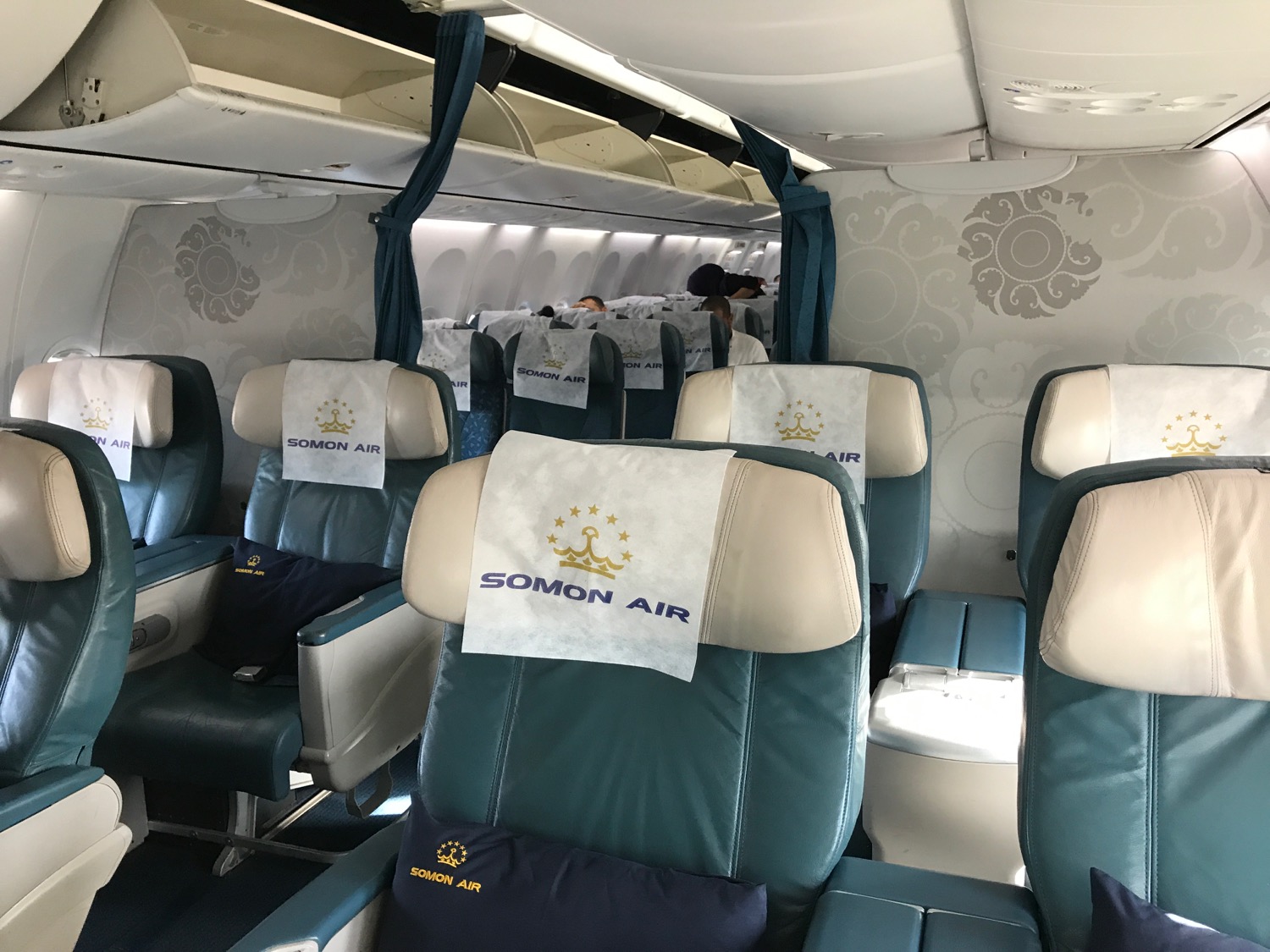the inside of an airplane with blue and white seats