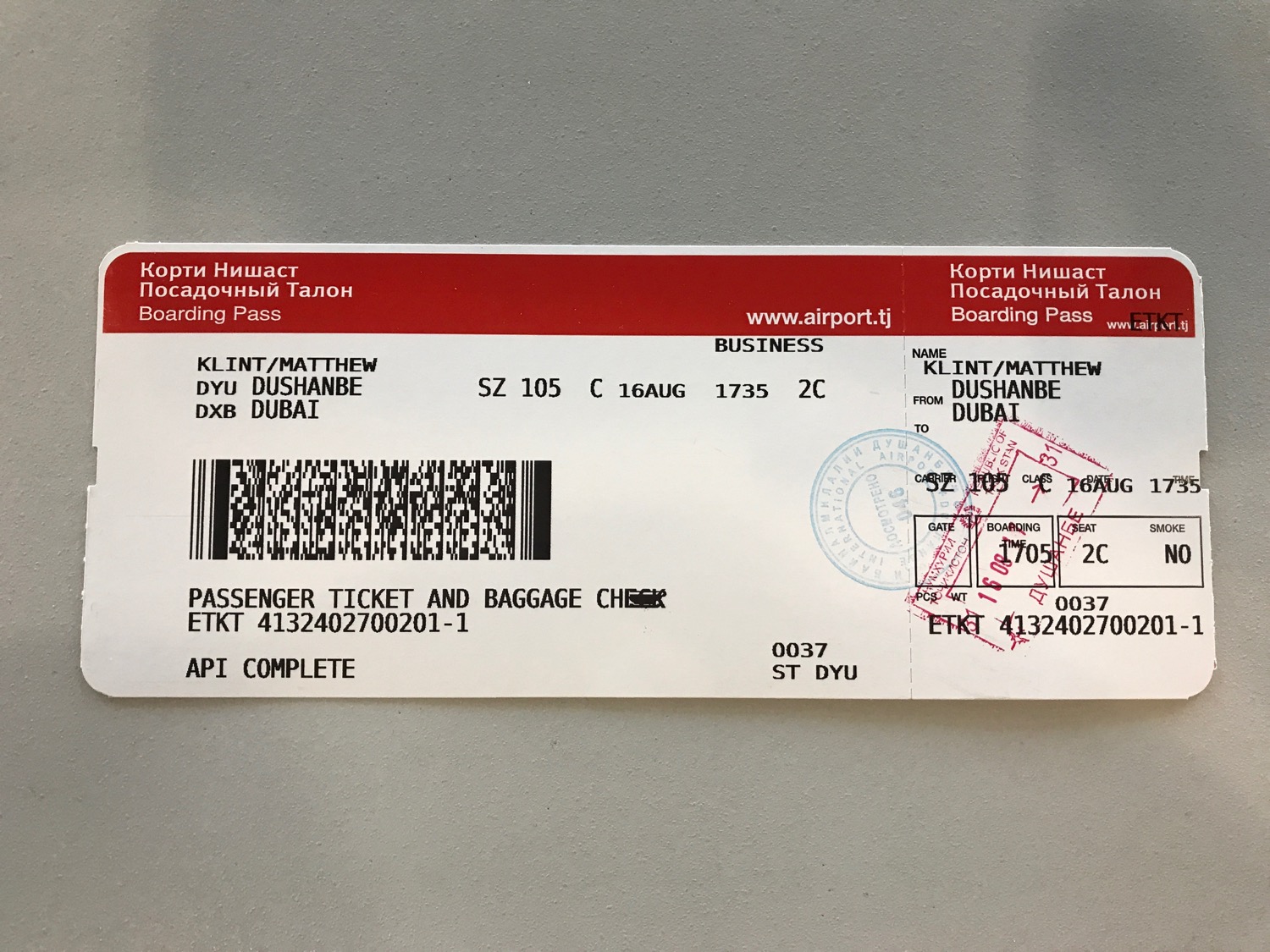 a white and red ticket with black text and a barcode