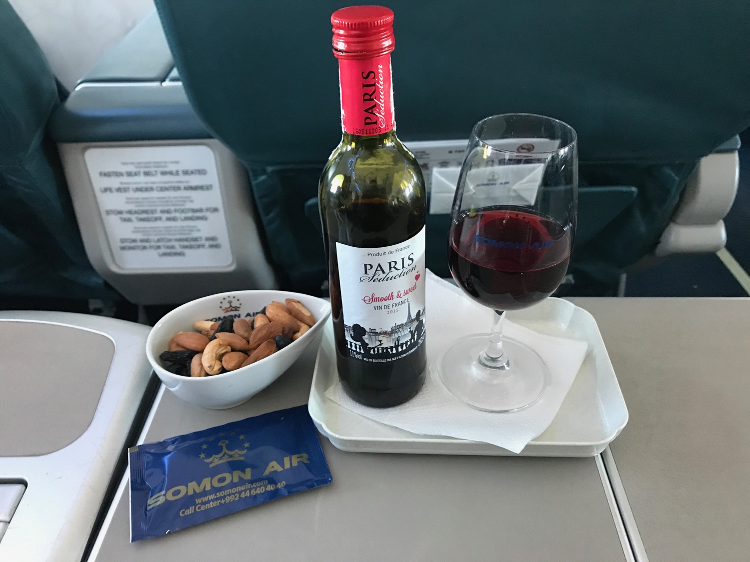 a bottle of wine and a glass of wine on a tray