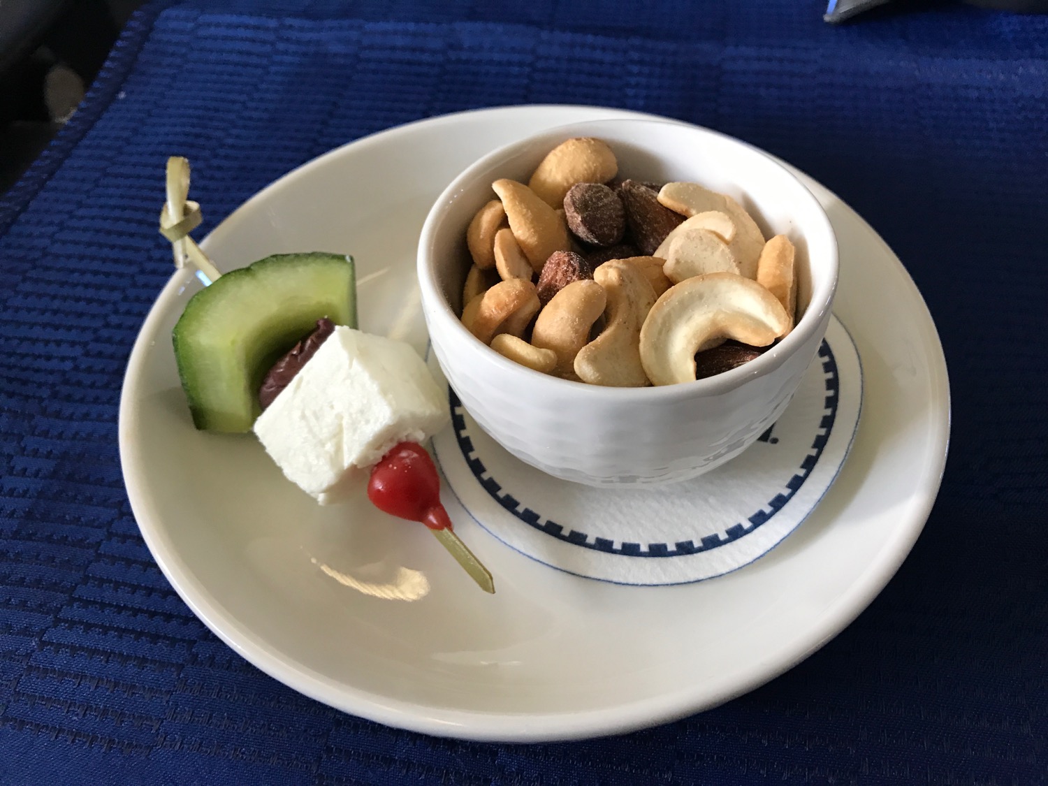 a bowl of nuts and cheese on a plate