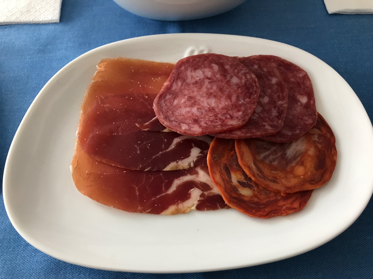a plate of meat and sausage