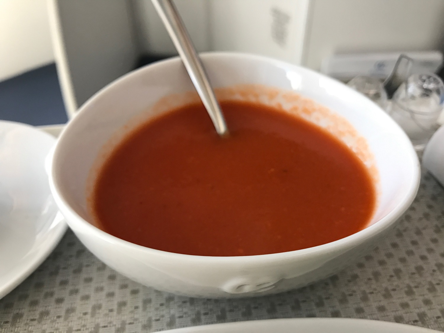 a bowl of red soup with a spoon