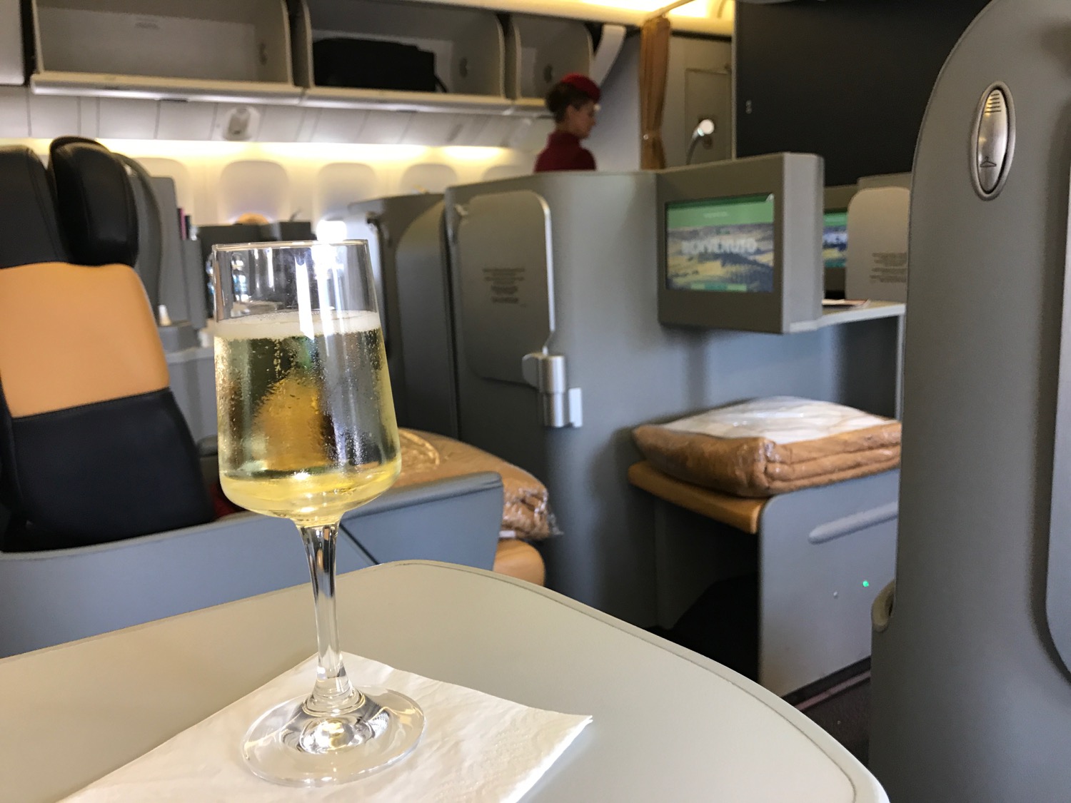 a glass of champagne on a table in an airplane
