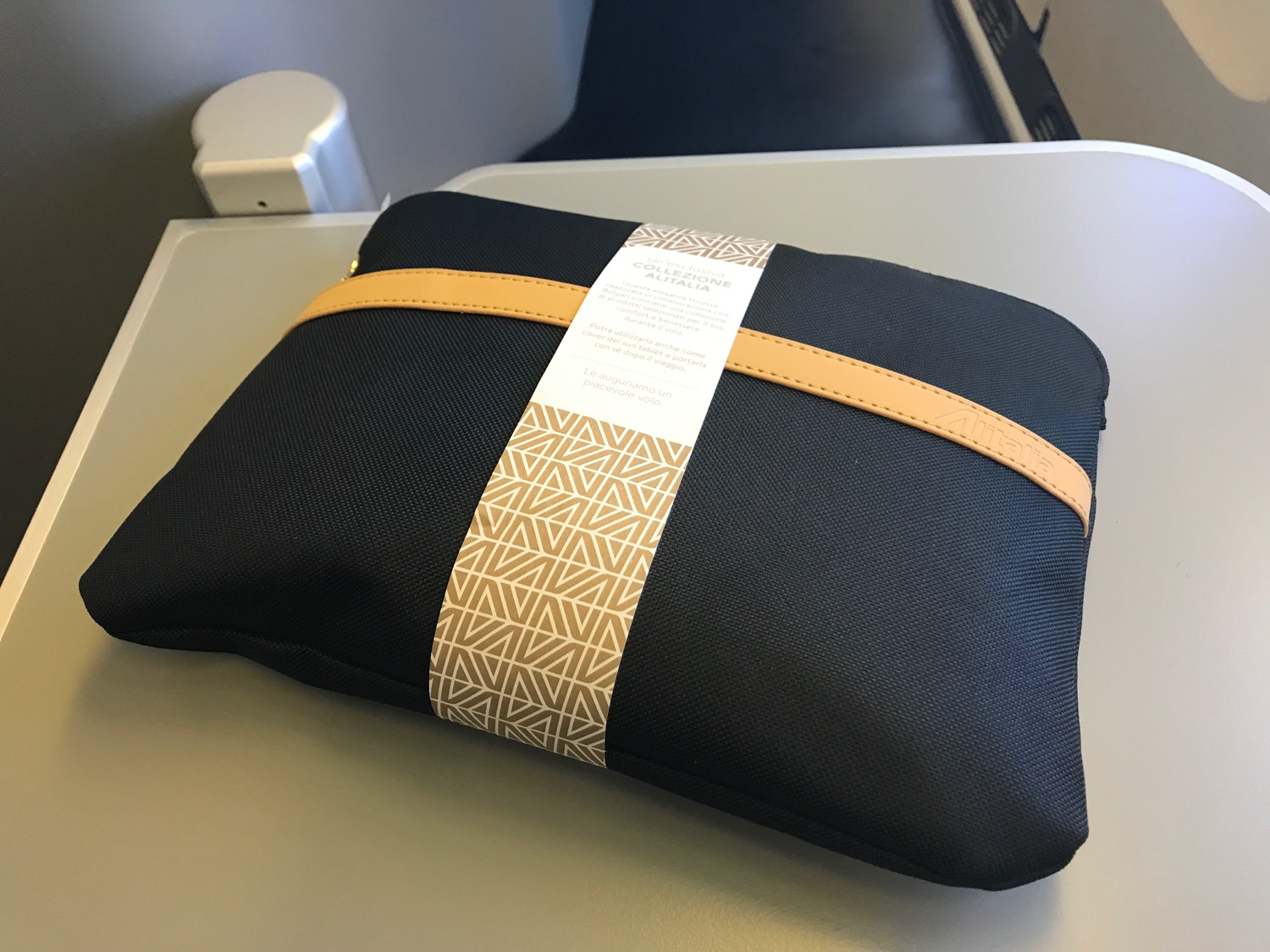 a black and tan bag with a white label