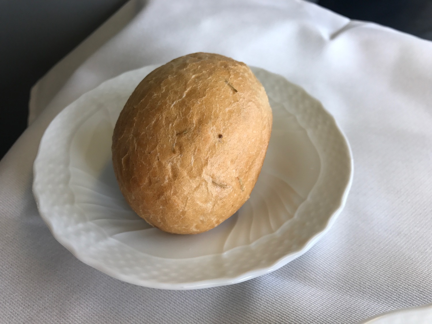 a round brown bread on a white plate