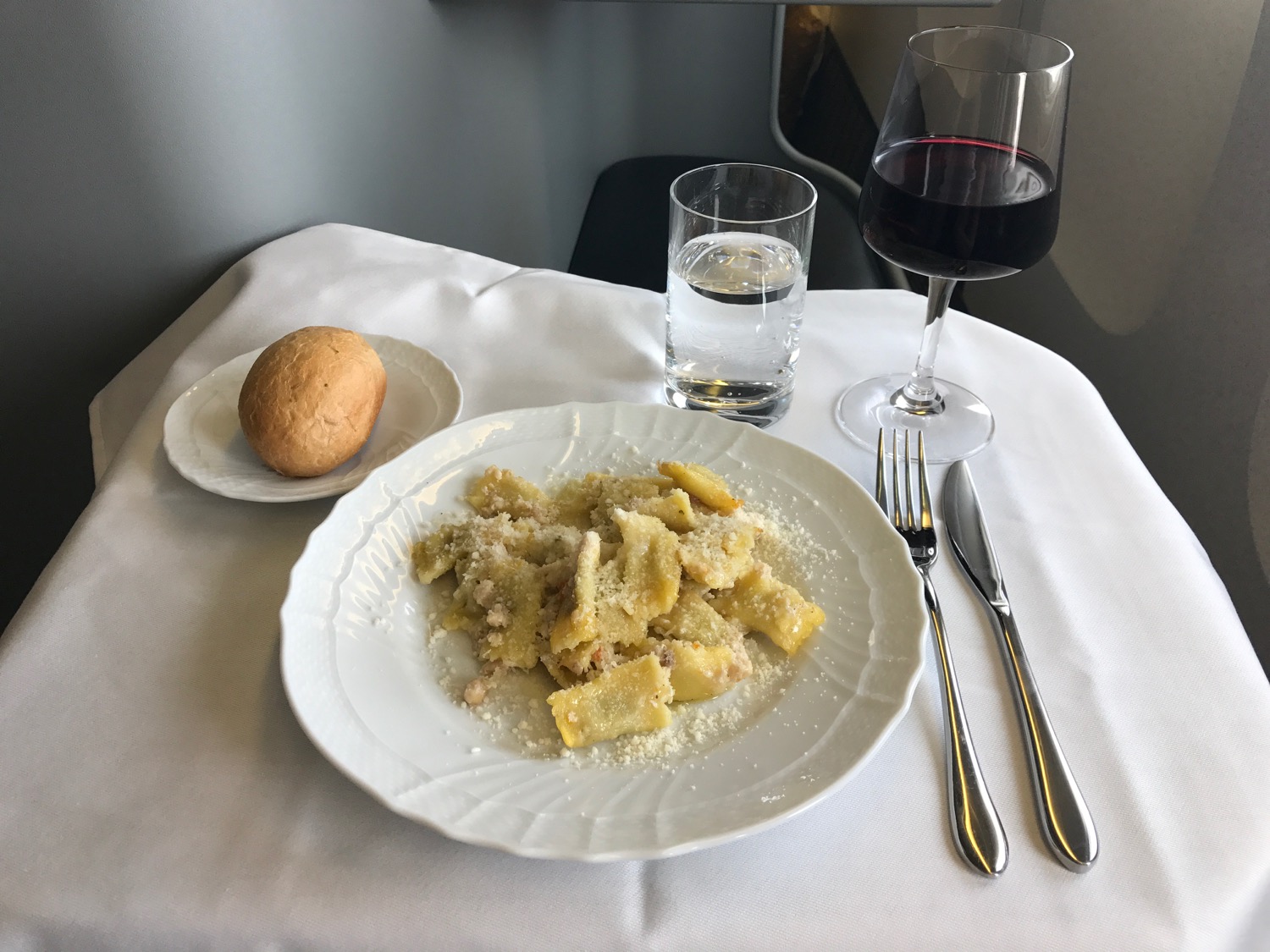 a plate of pasta and a glass of wine