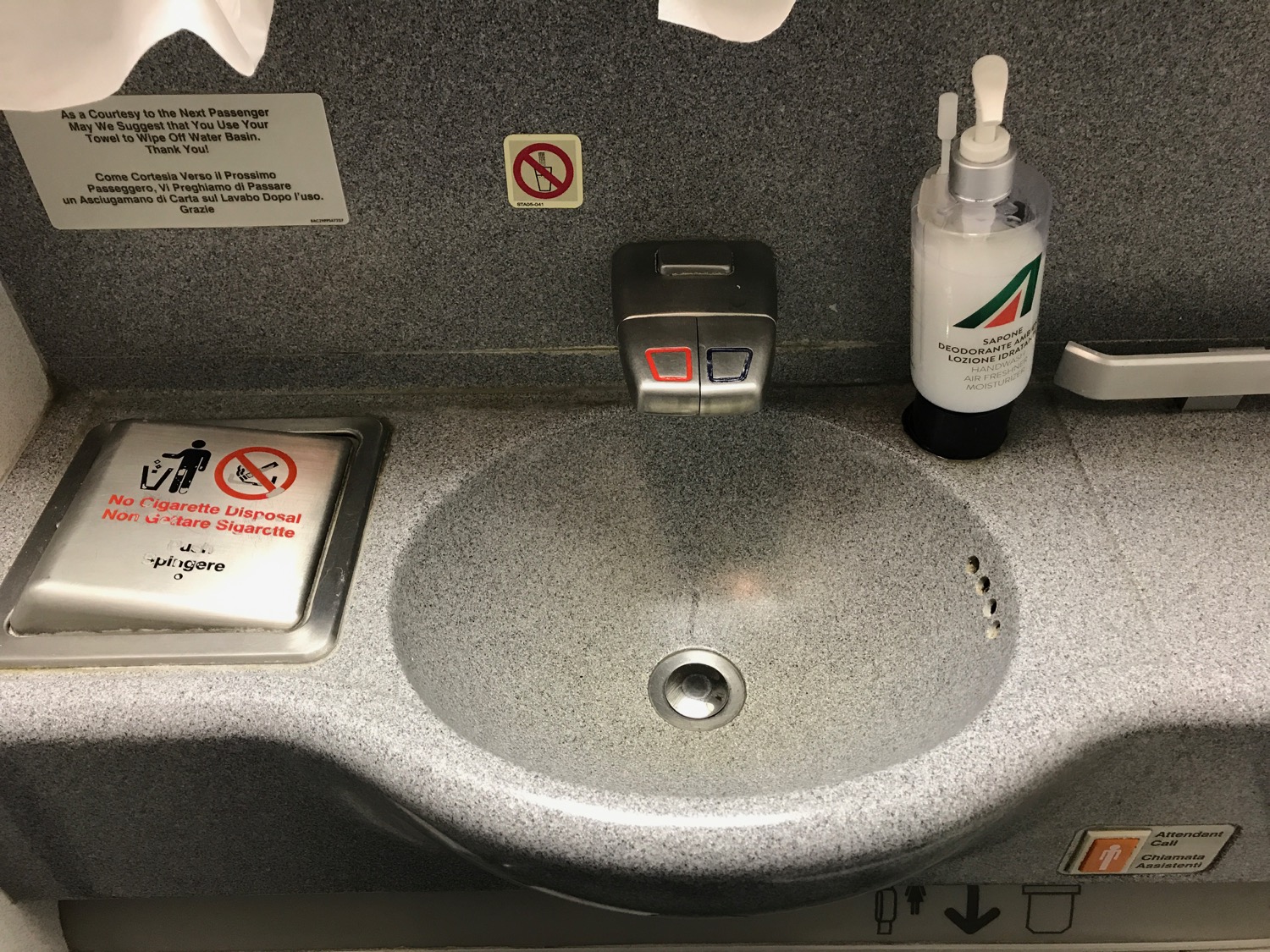 a sink with a bottle of liquid on it