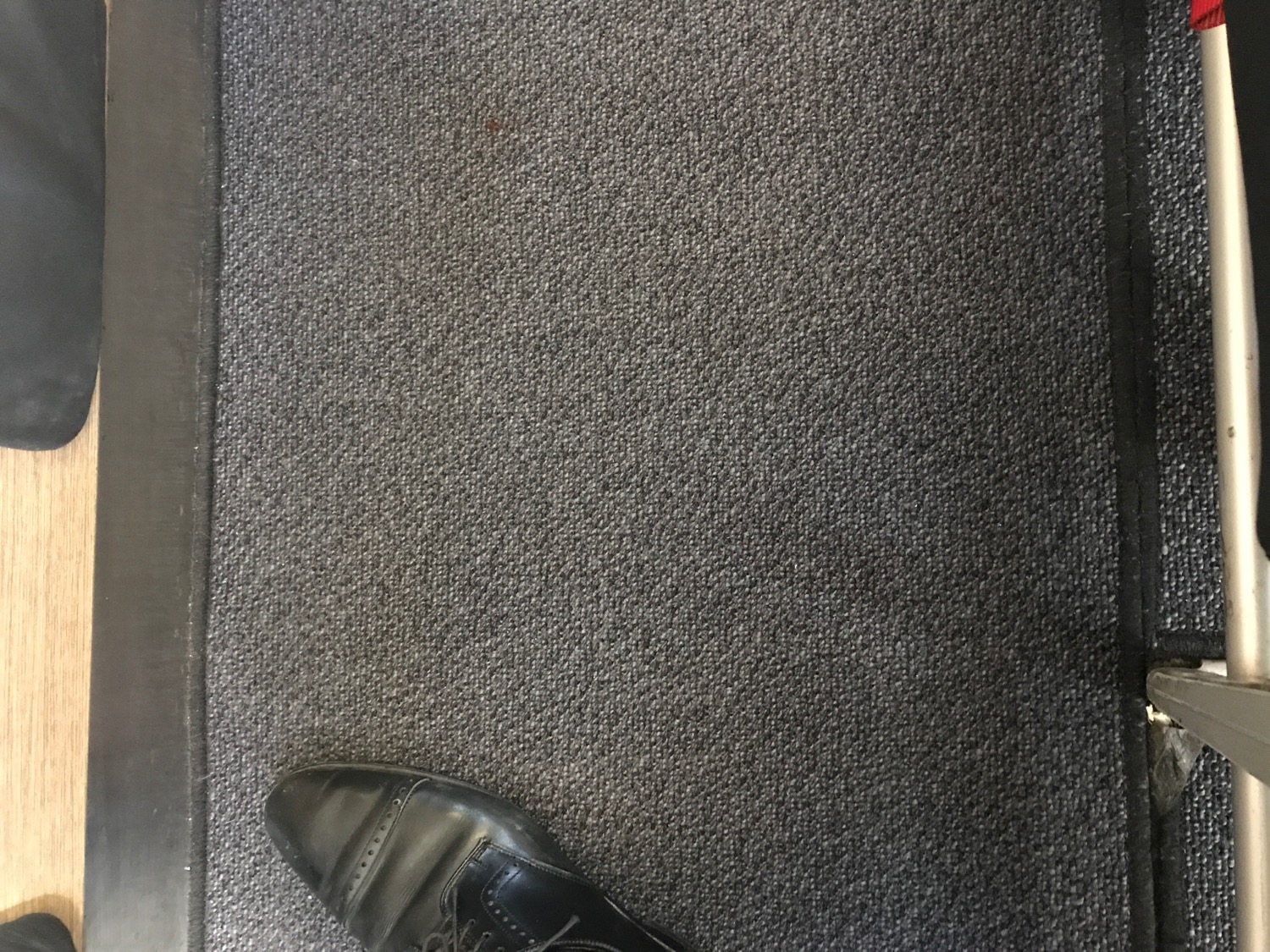 a black shoe on a carpet