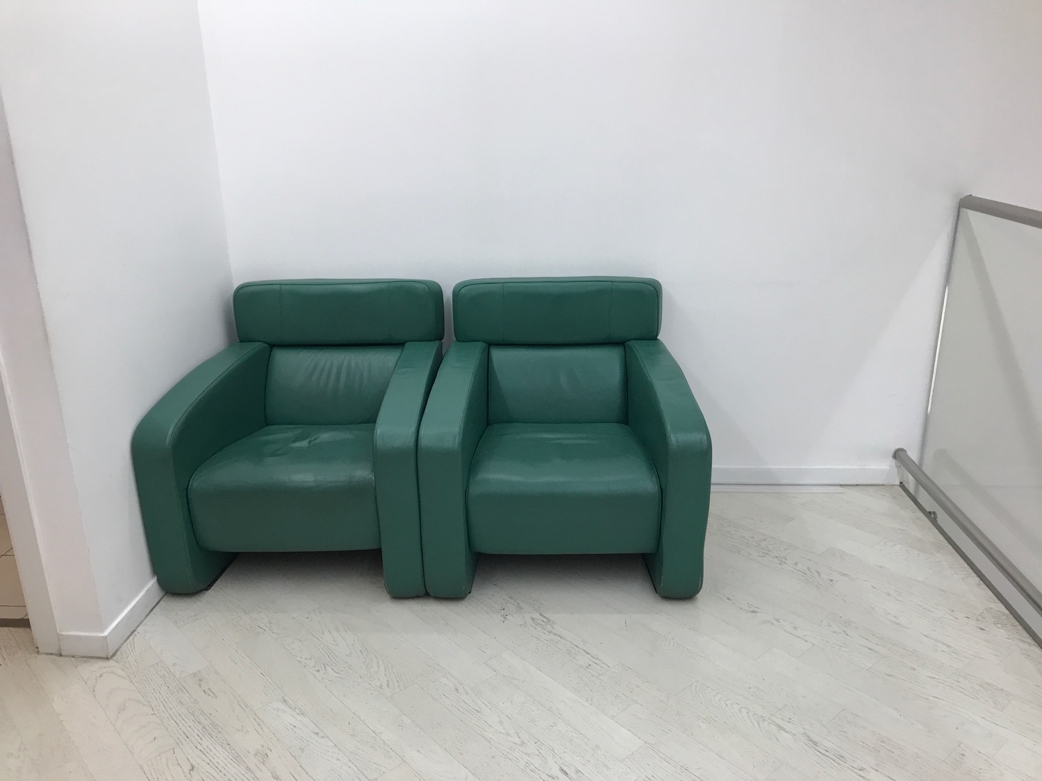 two green chairs in a room