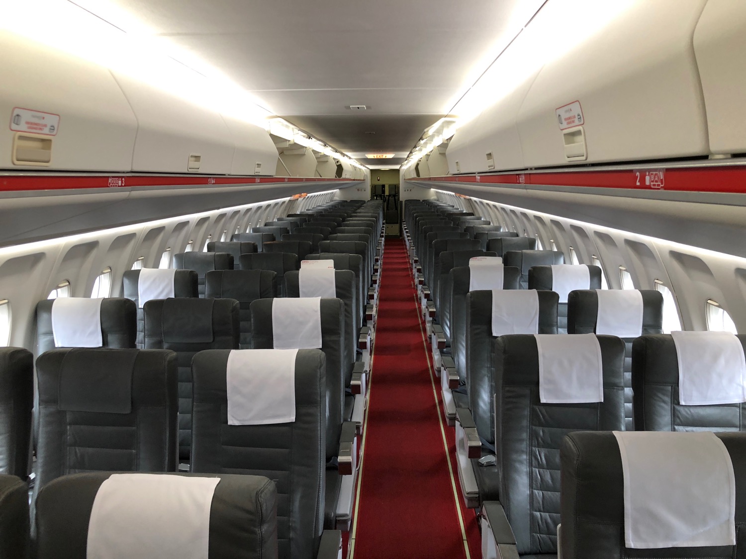 an airplane with seats and red carpet