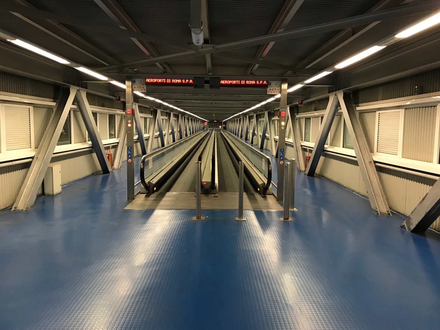 a walkway with a blue floor