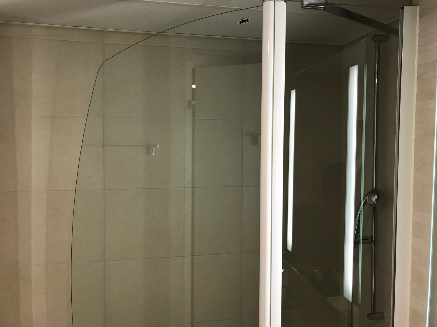 a glass shower door in a bathroom