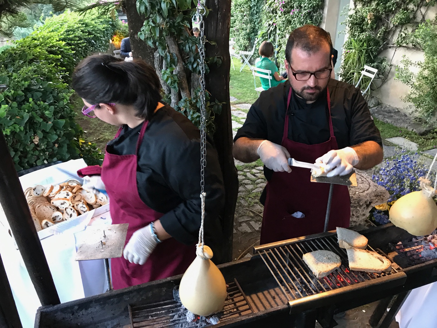 a man and woman cooking food on a grill
