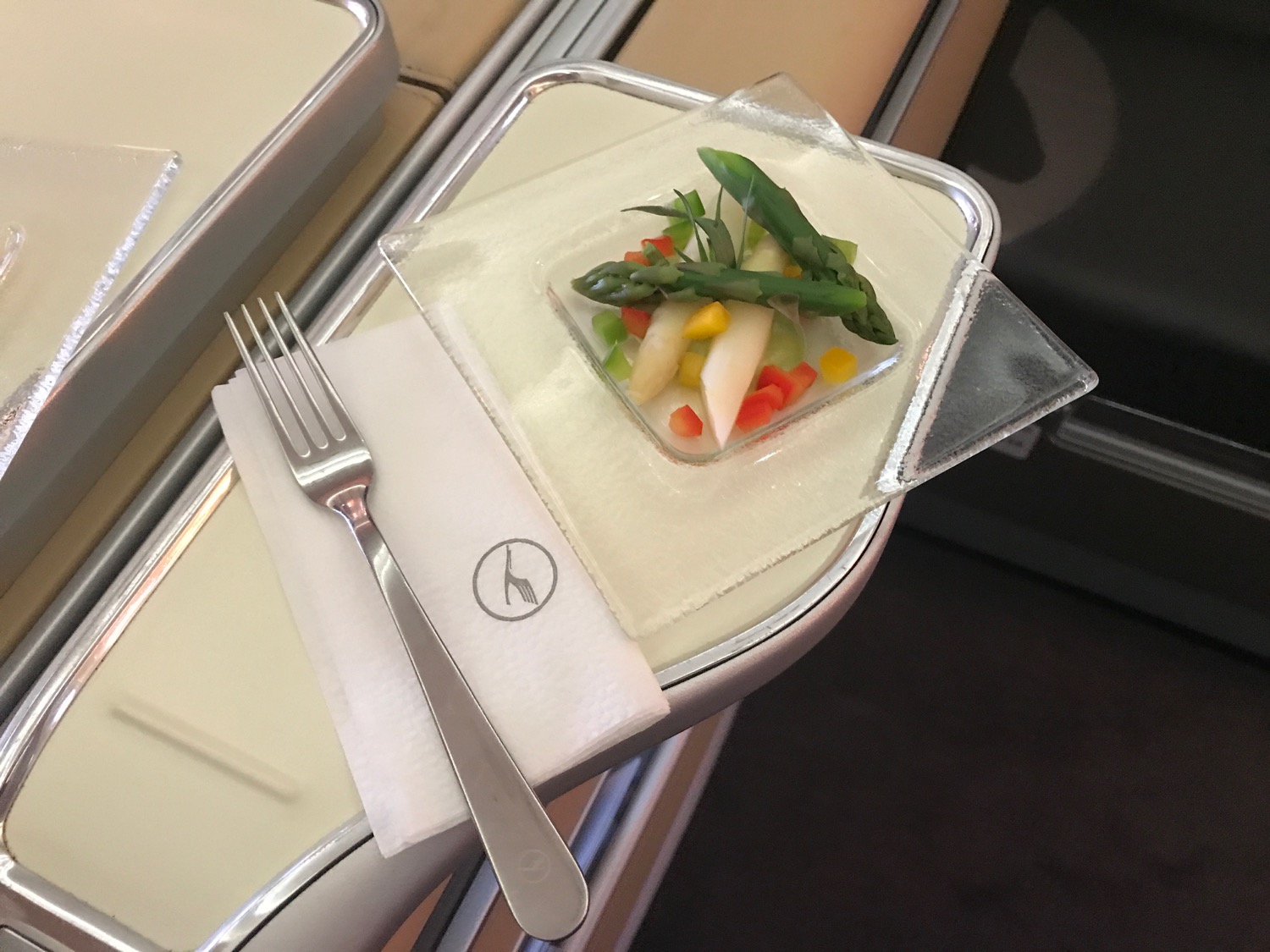 a plate of vegetables and a fork on a napkin