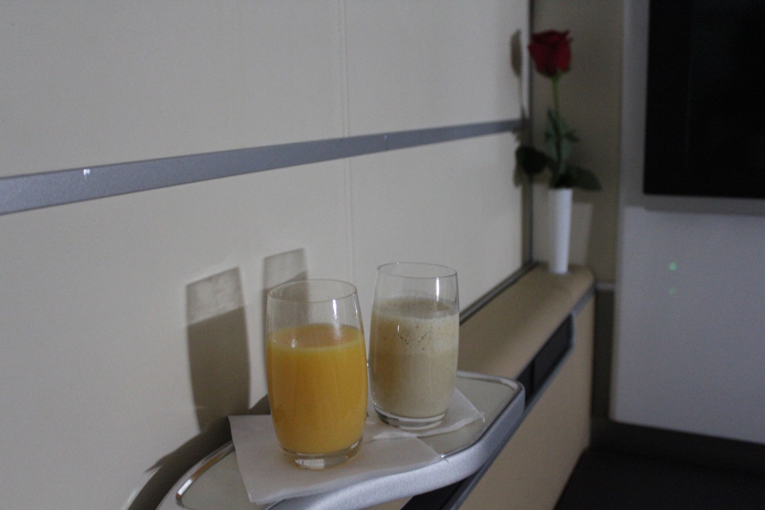 two glasses of orange juice on a tray