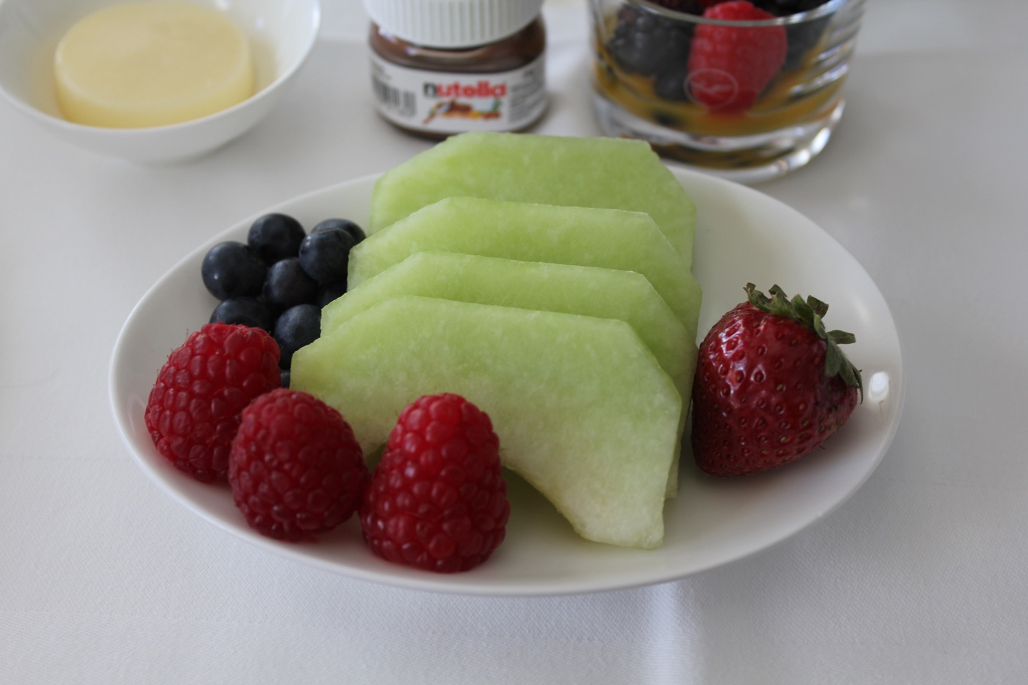 a plate of fruit and berries