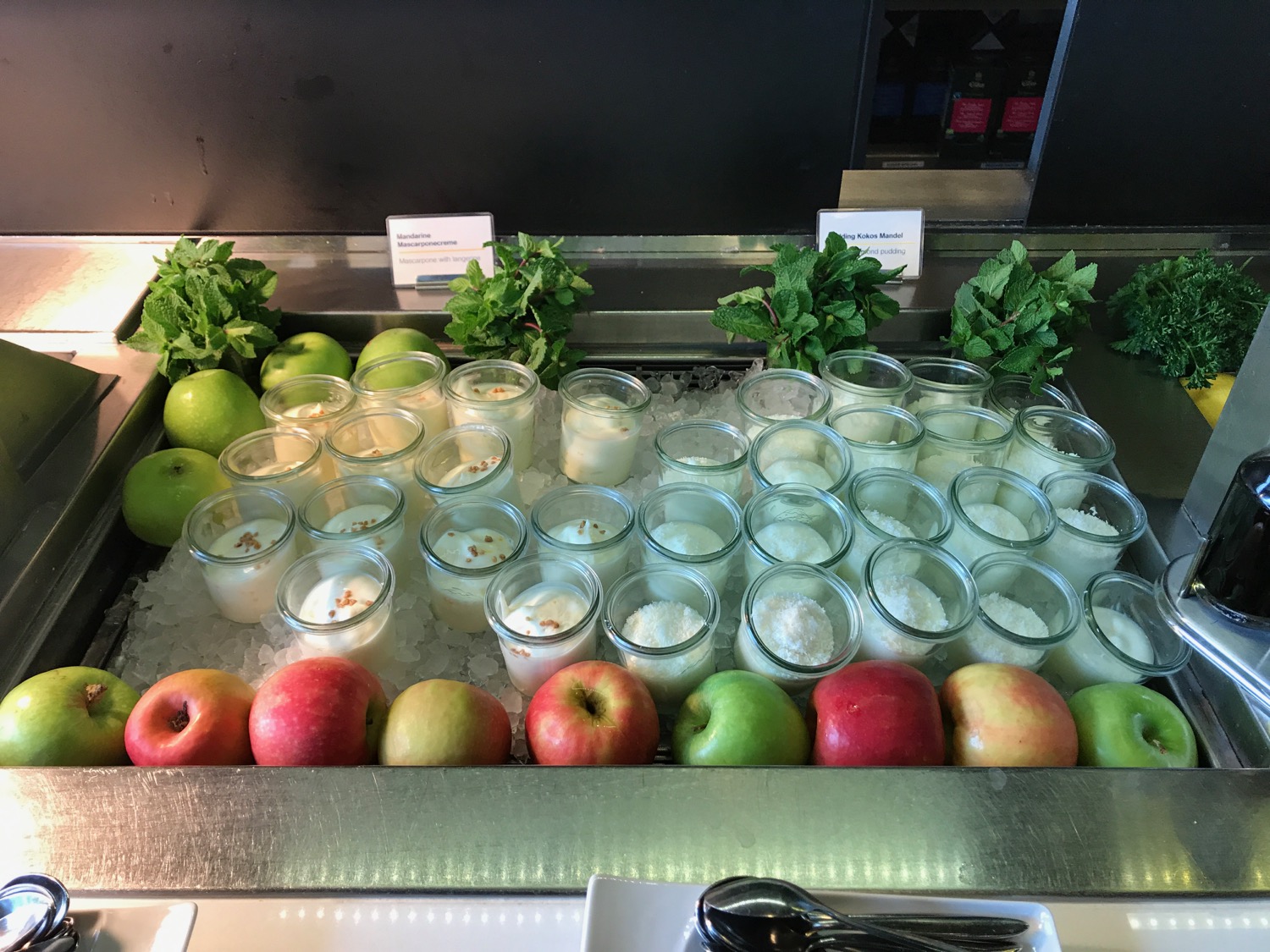 a group of glasses of yogurt and fruit on ice