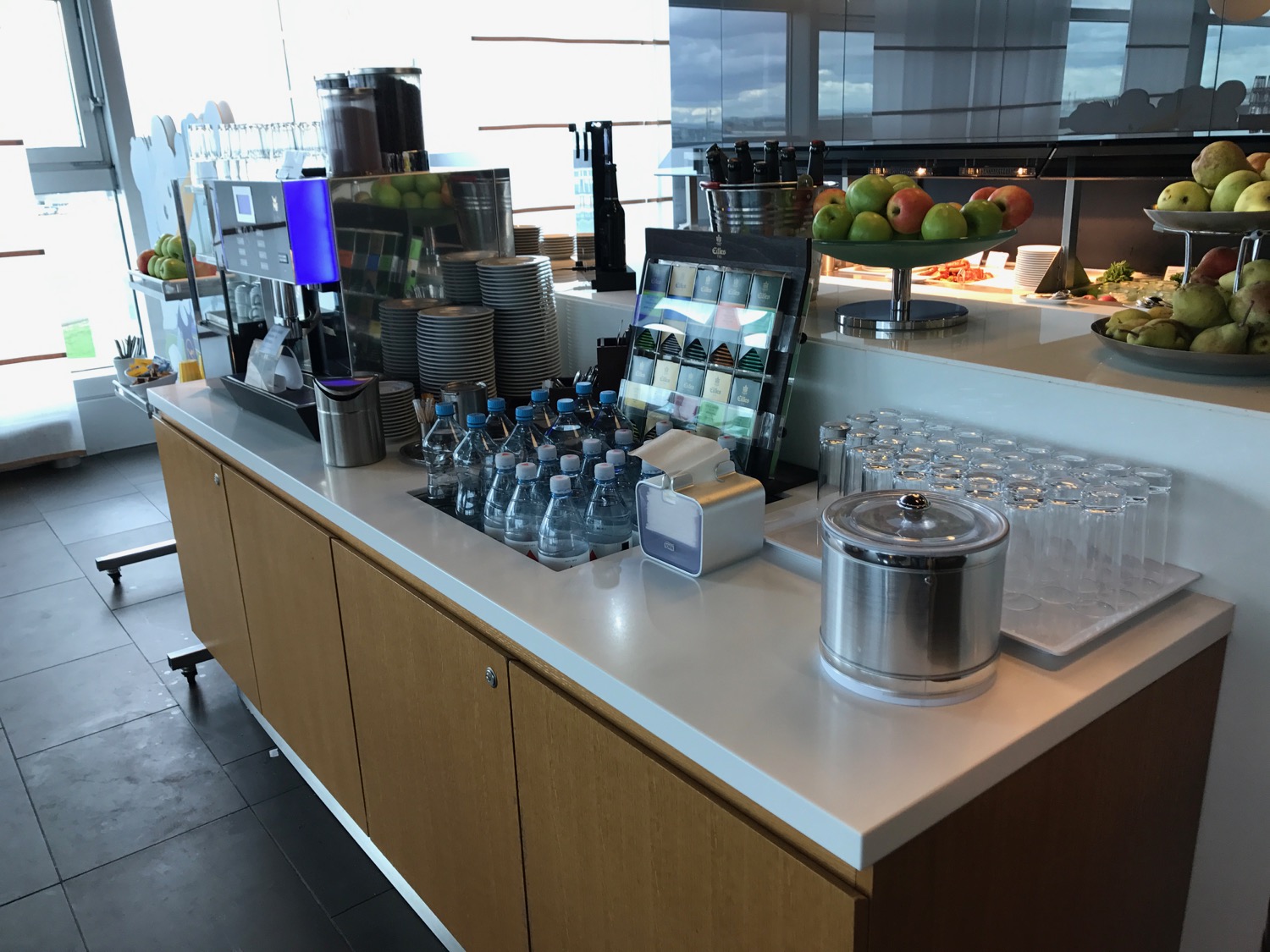 a counter with a variety of drinks and fruits