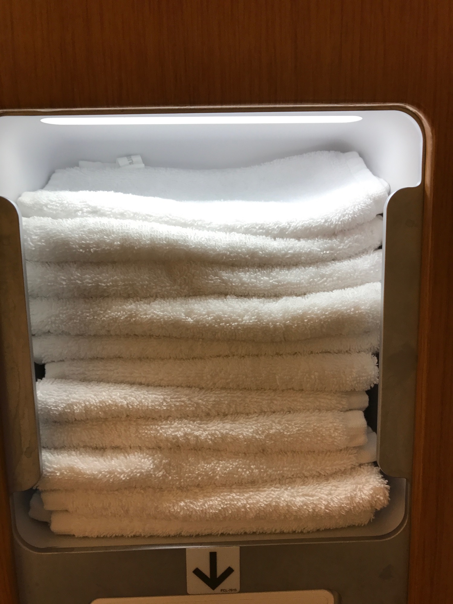 a stack of white towels in a shelf
