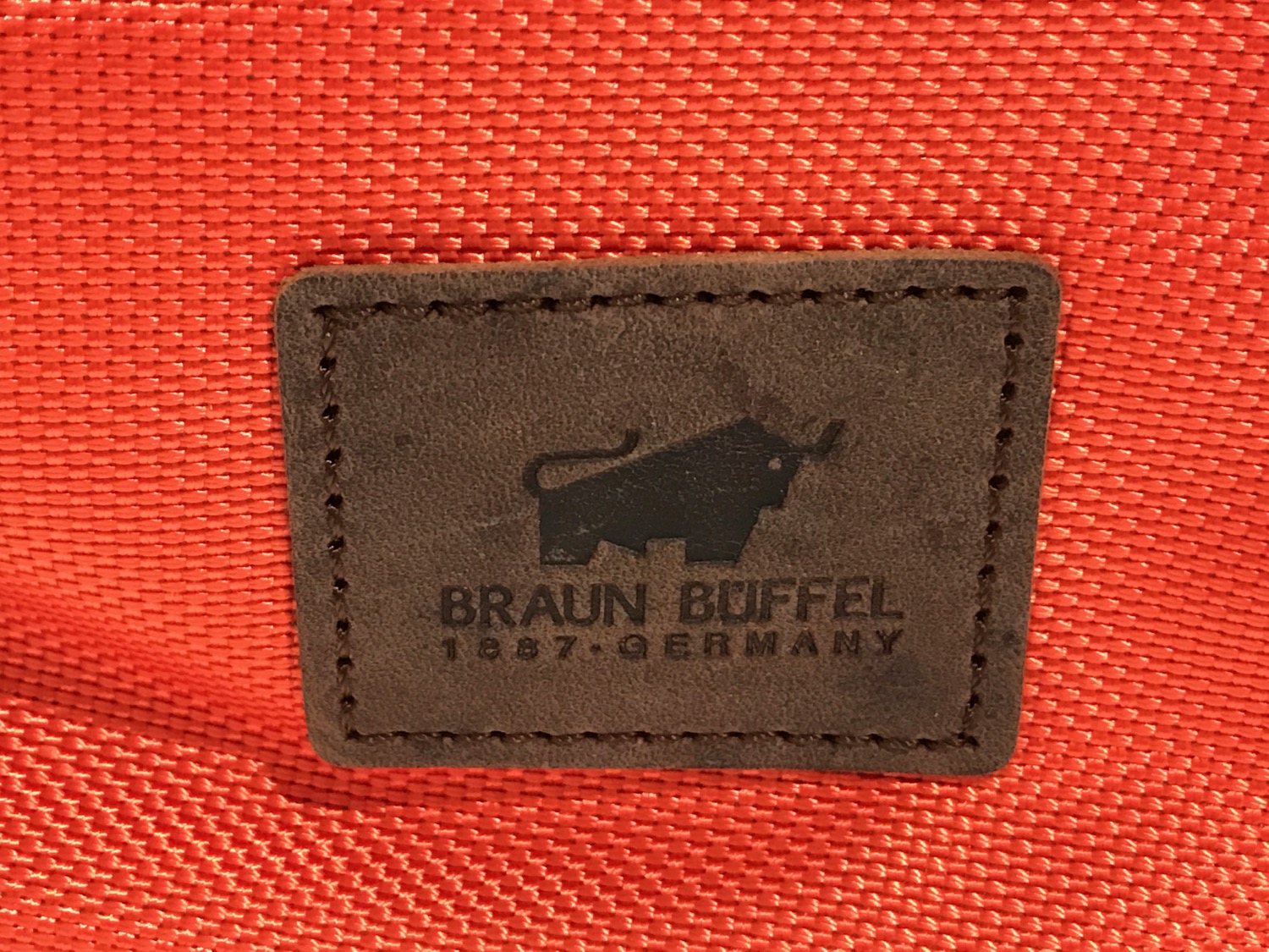 a leather label on a red fabric