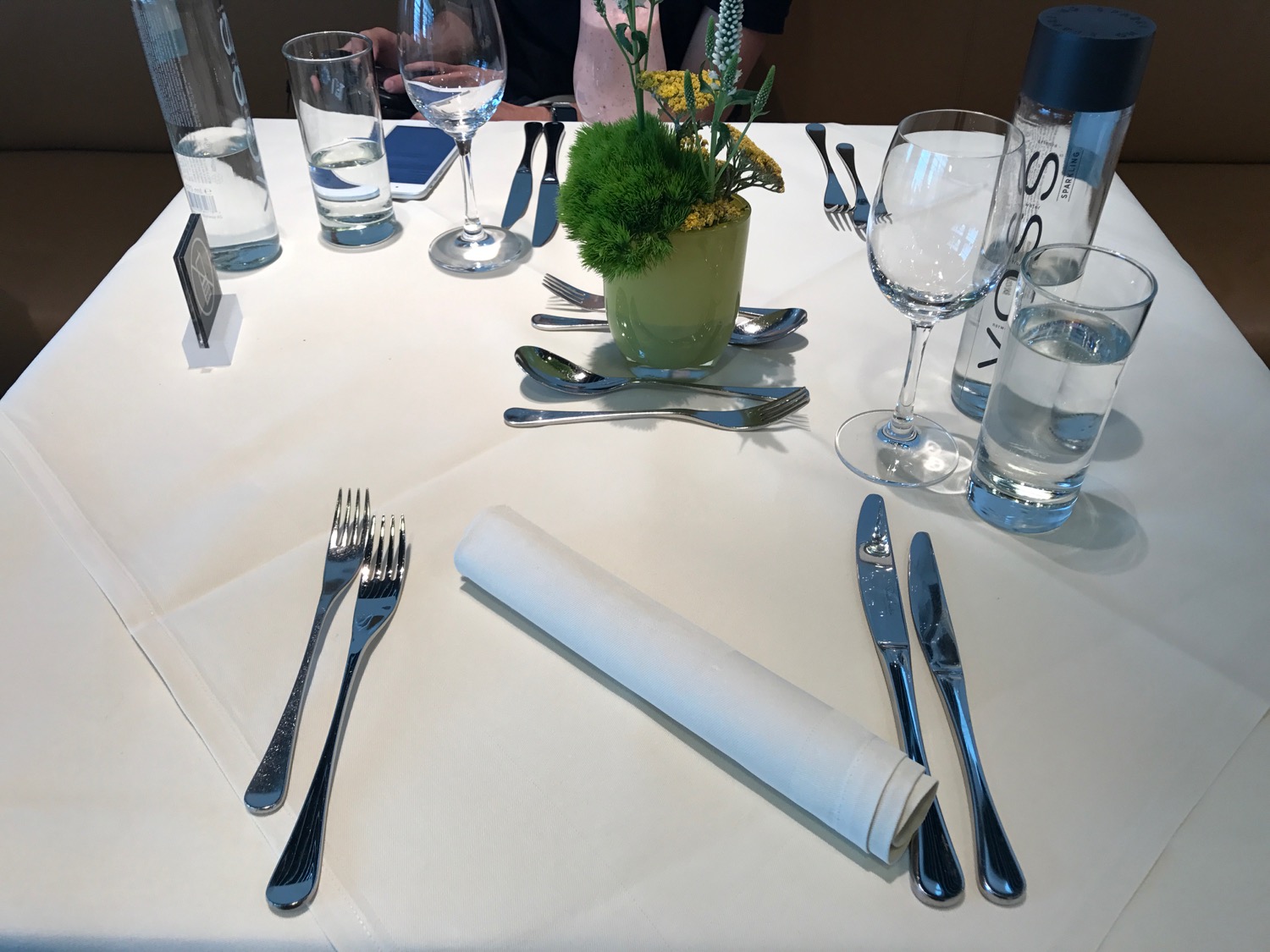 a table with silverware and glasses