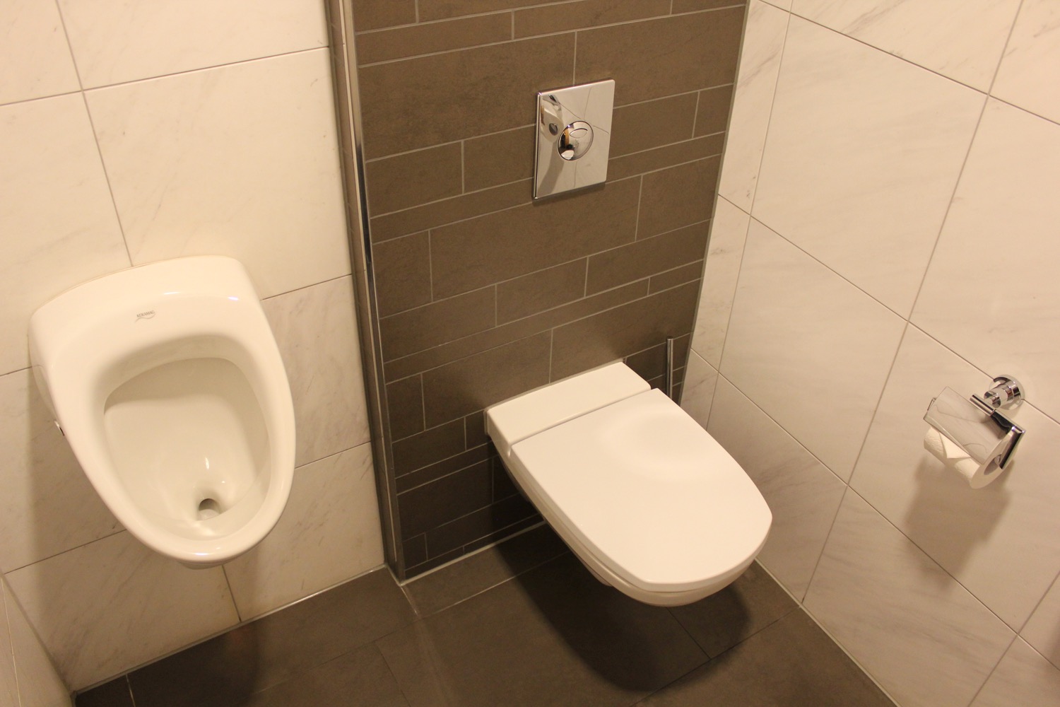 a toilet and urinal in a bathroom
