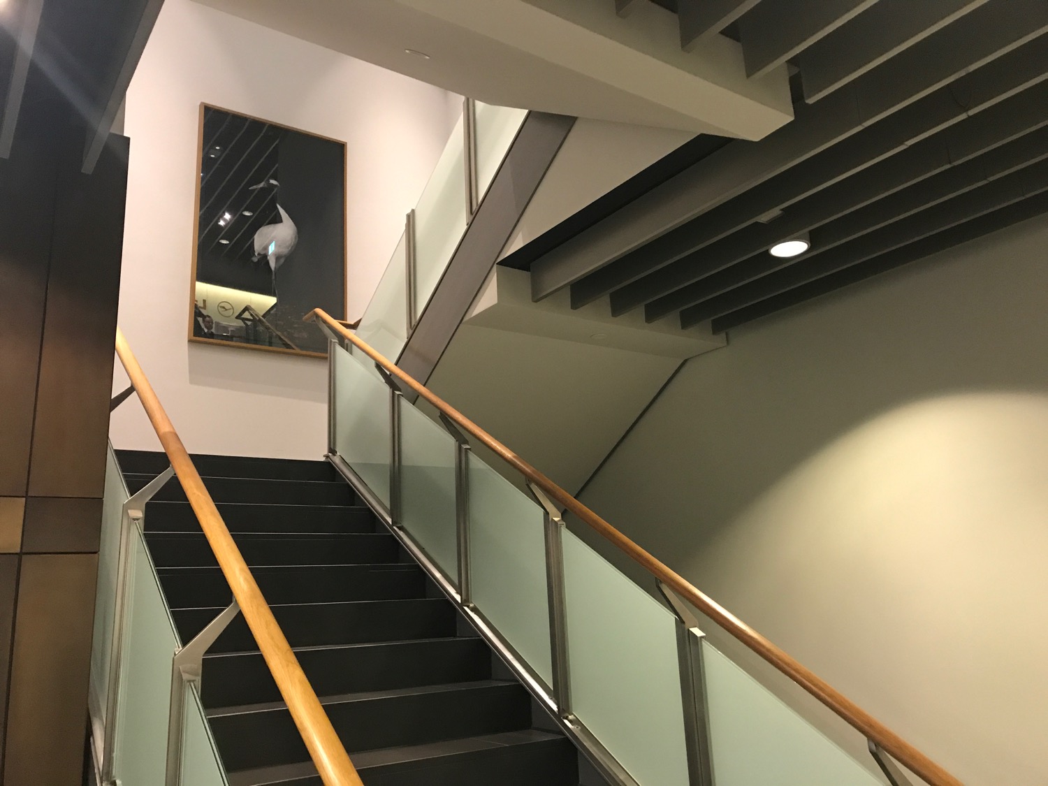 a staircase with a painting on the wall
