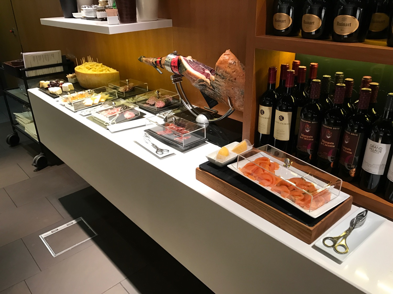 a counter with food and bottles of wine